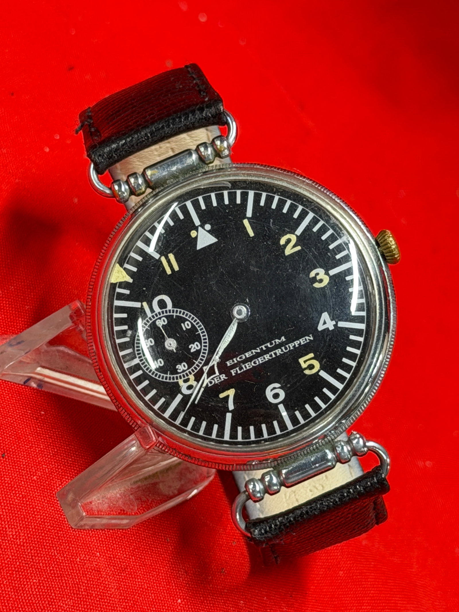 WW2 German Luftwaffe Pilot Wristwatch “Eigentum Der Fliegertruppen?? Anchor 15 Rubies: World War II era German Luftwaffe style pilot wristwatch marked “Eigentum Der Fliegertruppen” on the dial, translating to “Property of the Flying Troops.” Features classic black milita