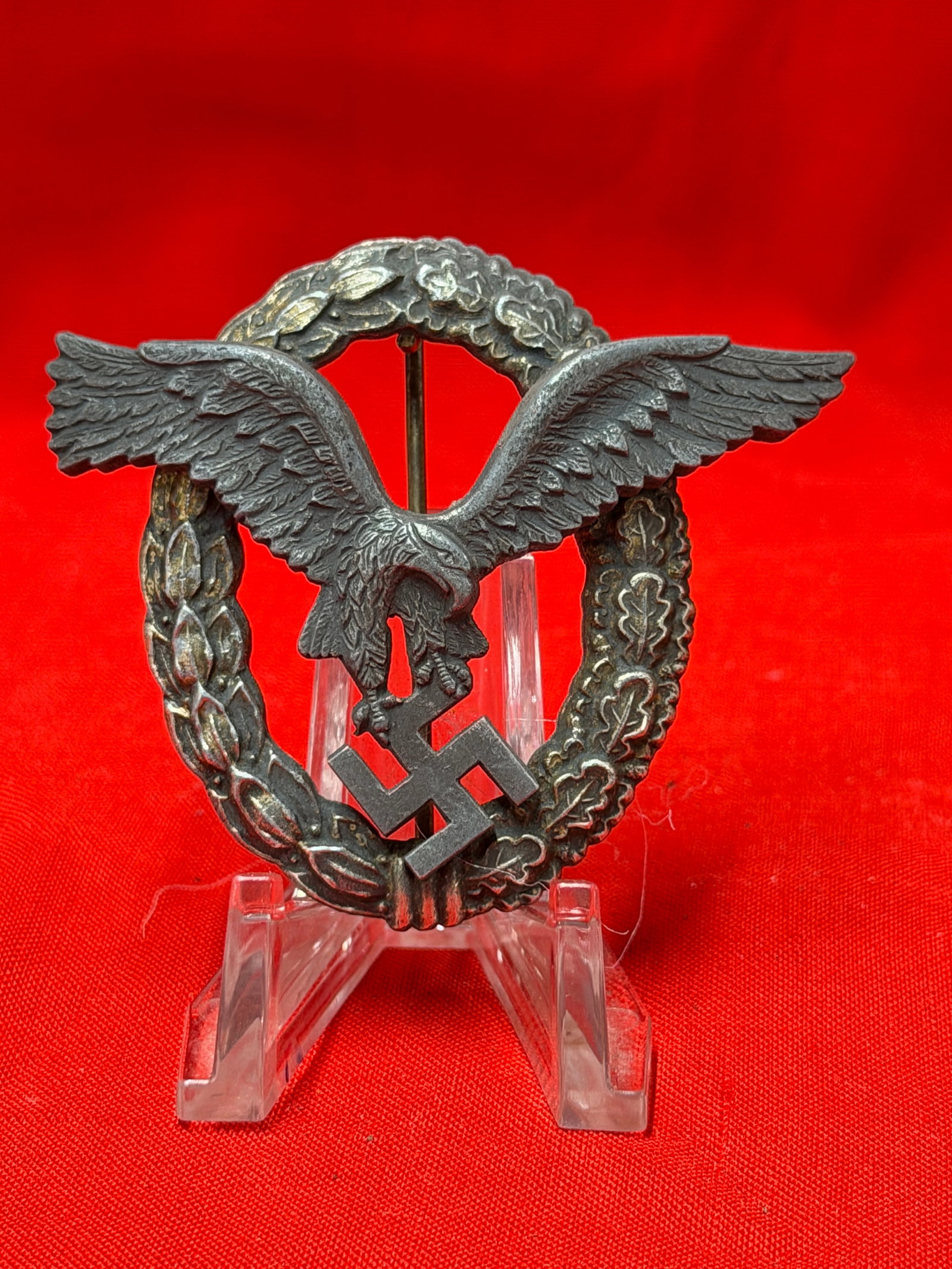 WW2 German Luftwaffe Air Gunner Badge by BME & Sohn Berlin: World War II German Luftwaffe Air Gunner badge featuring the classic flying eagle clutching a swastika within an oval oak leaf wreath. The reverse is maker marked “B.M.E. BAUER BERLIN,” a know