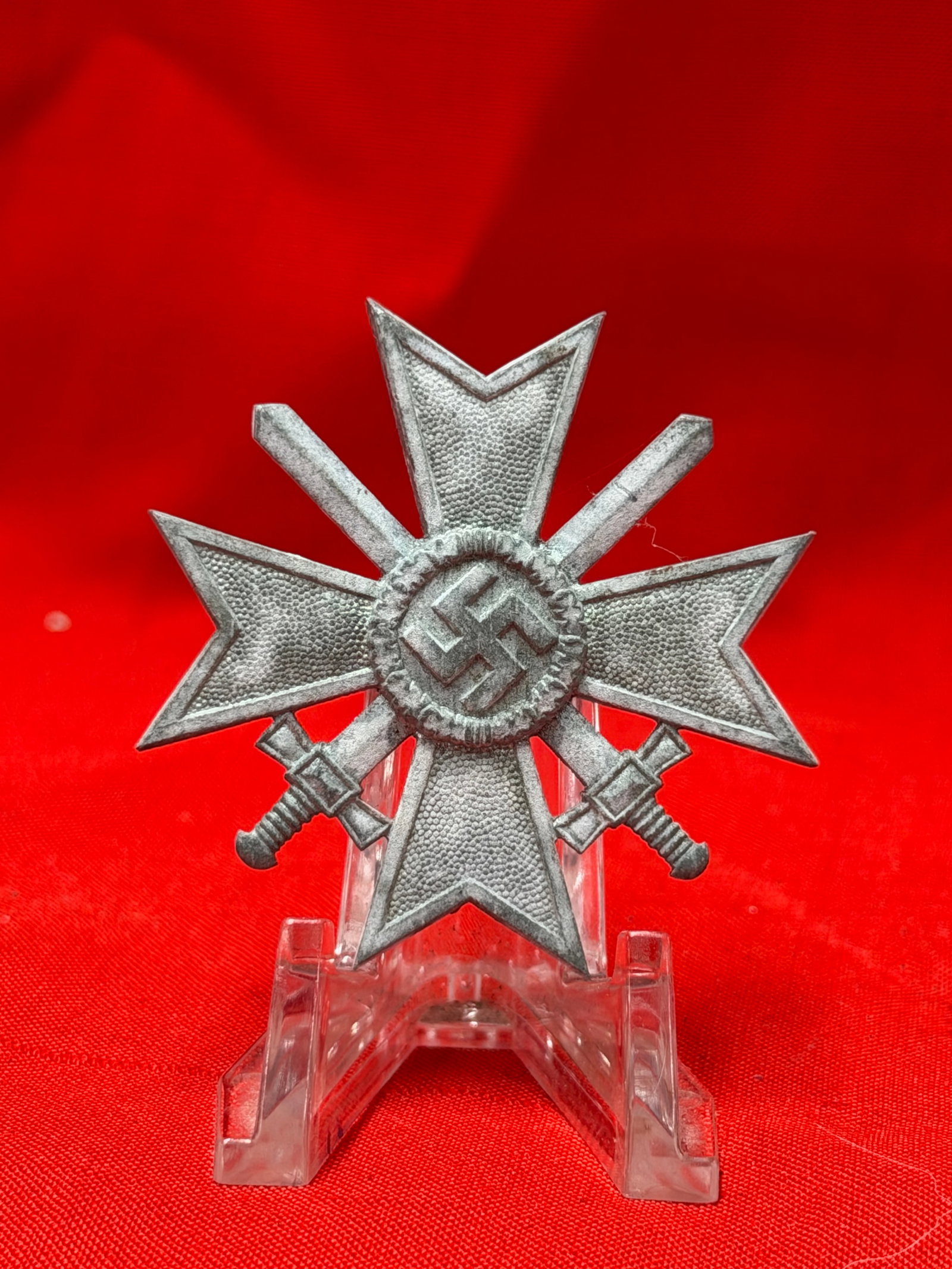 German War Merit Cross With Swords Pinback Badge Marked 3: German War Merit Cross with crossed swords design and pinback attachment on reverse. Reverse hardware includes maker mark “3” stamped on pin. In our opinion, this piece appears to be a period 