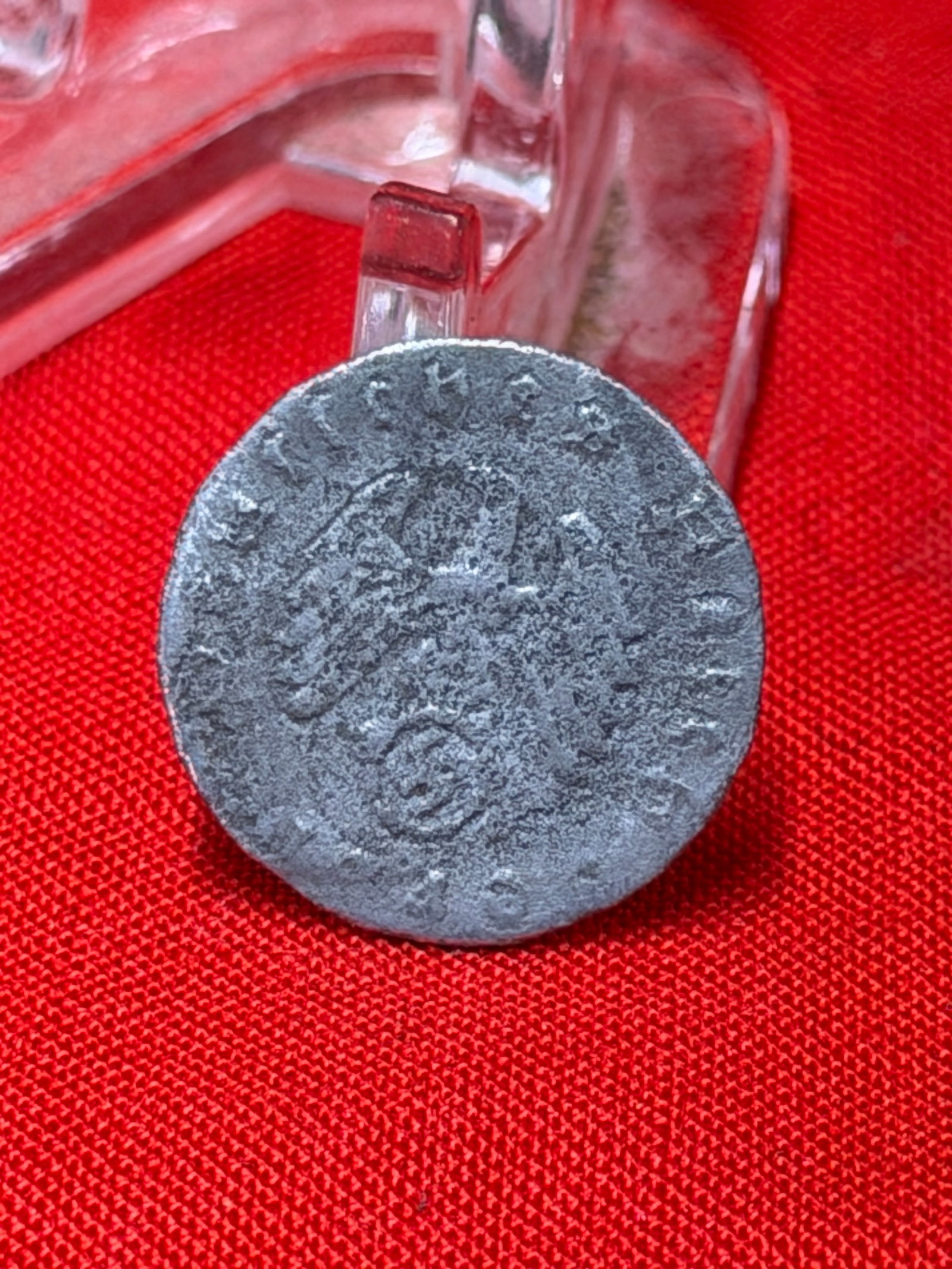 WWII German 5 Reichspfennig Coin: WWII-era German 5 Reichspfennig coin featuring the national eagle design on one side and large numeral “5” denomination on the reverse. The coin shows heavy circulation wear, oxidation, surfac