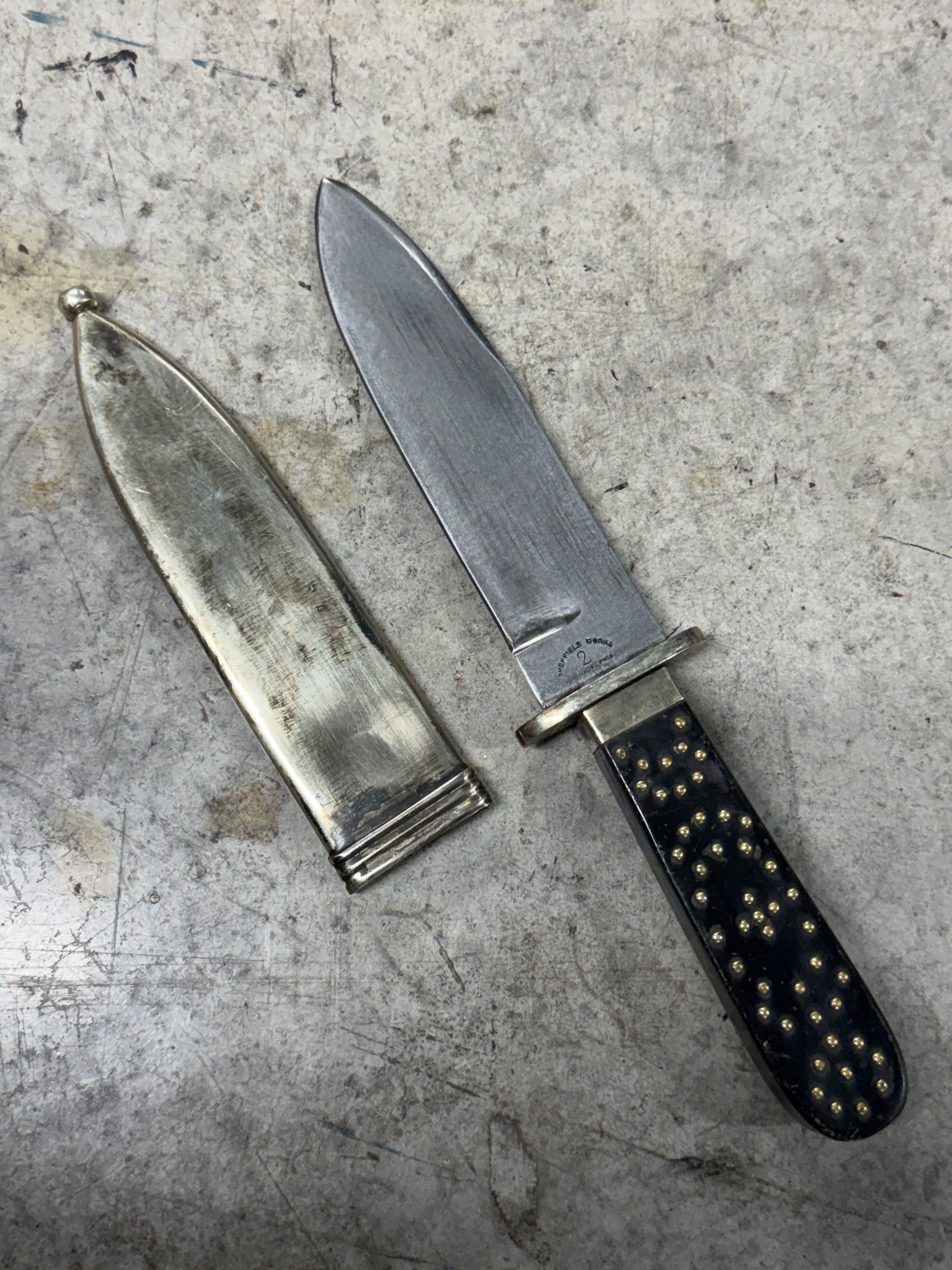 1800's Sheffield Works “2 Philadelphia?? Bowie Knife with Metal Scabbard: 19th century Bowie knife marked “SHEFFIELD WORKS” over “2 PHILADA” features a broad spear point steel blade with simple unfullered profile and nickel silver mounted handle retaining it