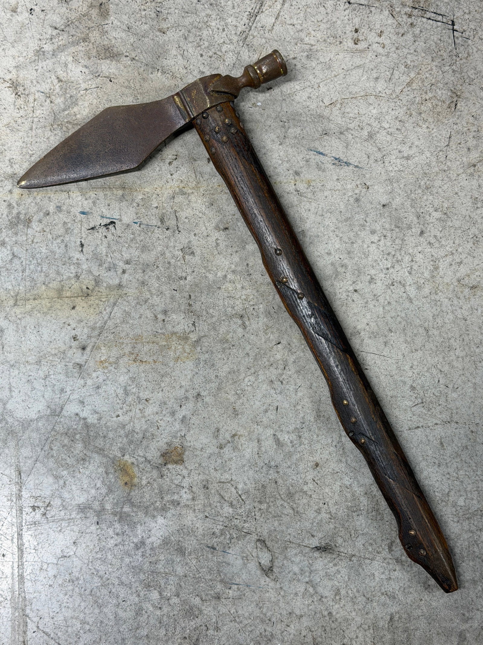 1800's Native American Smoking Pipe Tomahawk Attributed to Cherokee Indians: In our opinion, this antique 19th century pipe tomahawk attributed to the Cherokee Indians features a forged iron head mounted to a long carved wooden haft with brass tack decoration throughout. The t