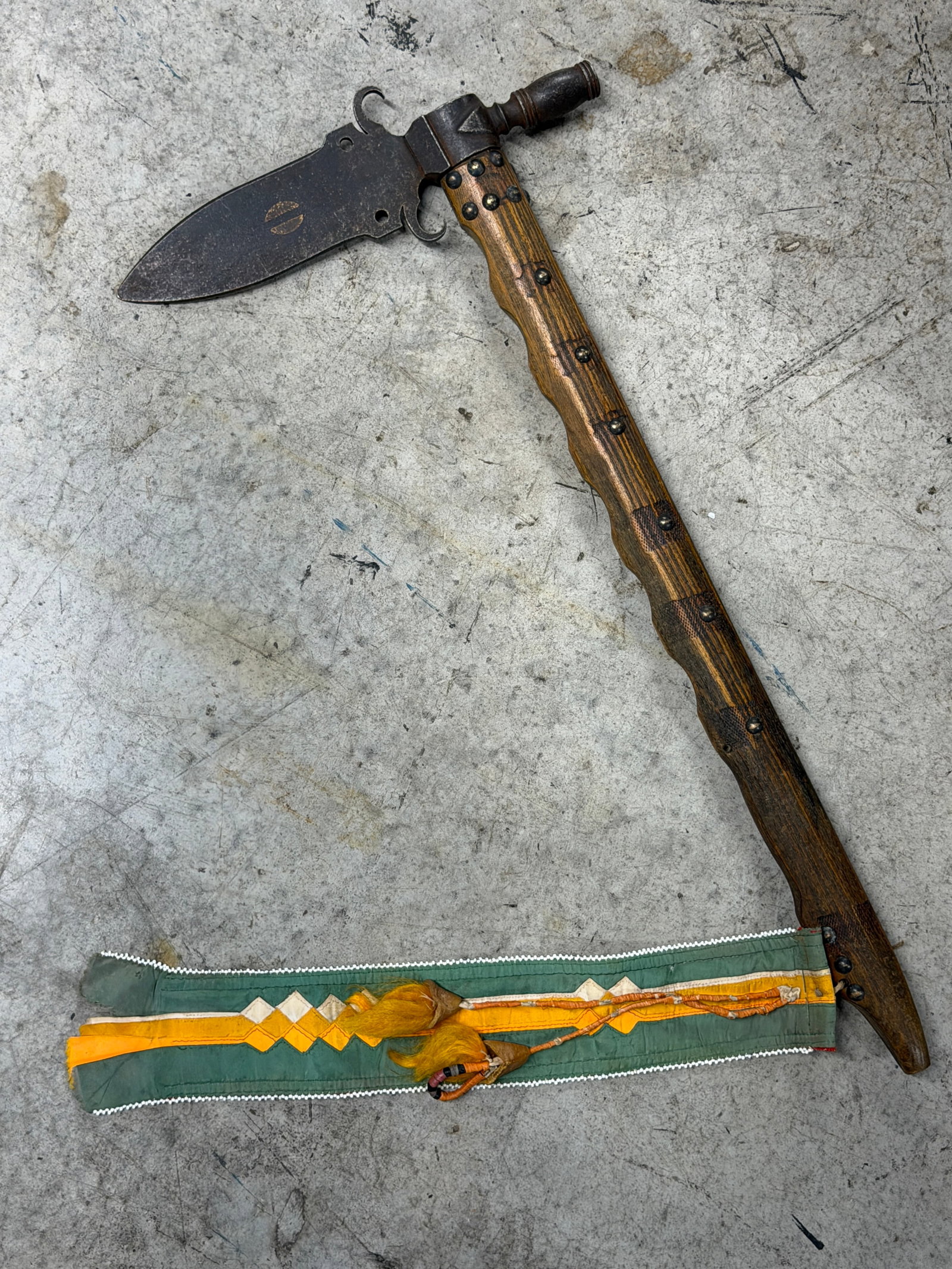 1800's Native American Pipe Tomahawk with Beaded Drop: 19th century Native American pipe tomahawk features a forged iron pipe head mounted to a hand carved wooden haft decorated with tackwork and an attached cloth and beaded drop. The tomahawk measures ap