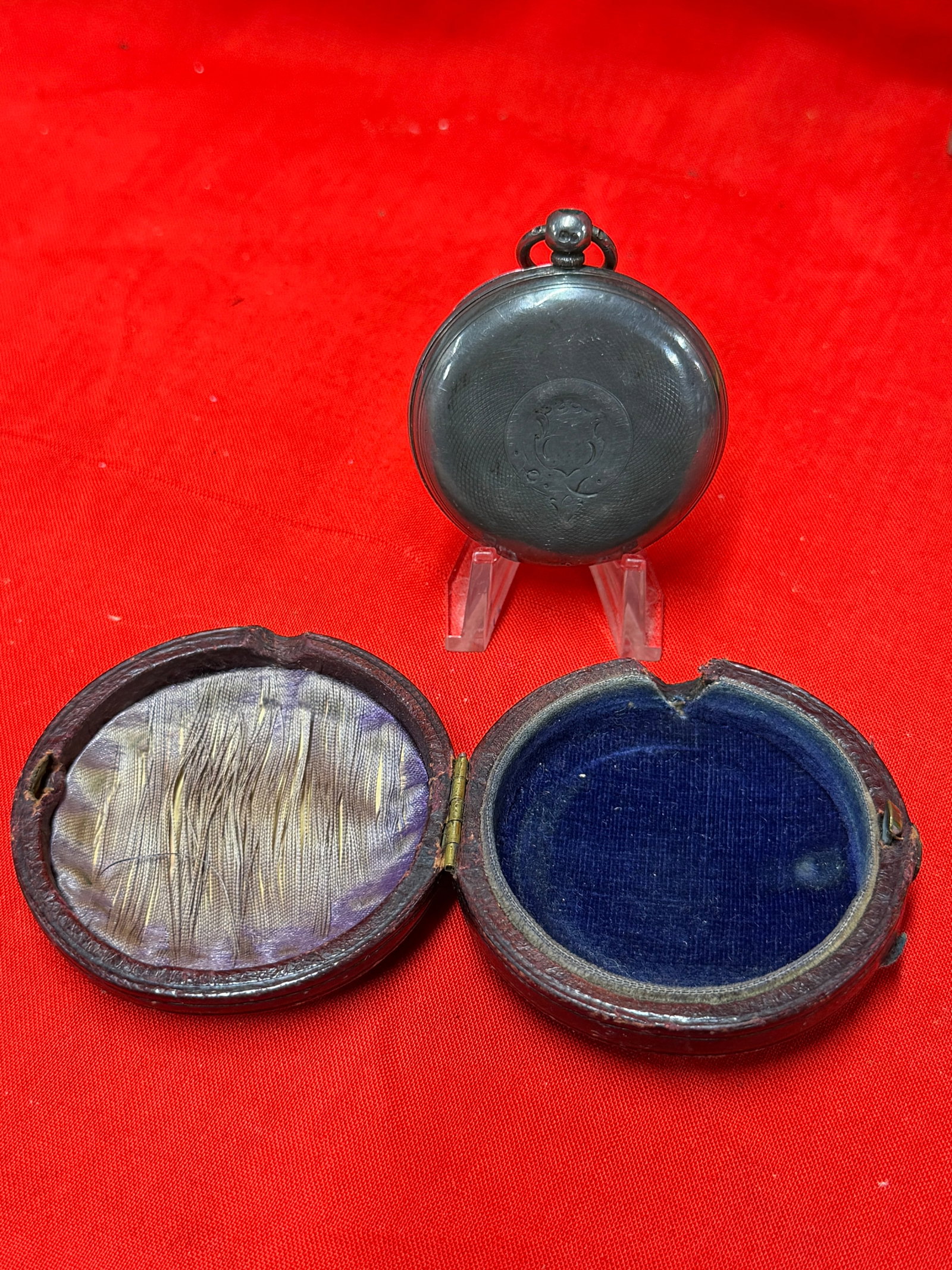 Civil War Era Pocket Watch With Leather Travel Case and Roman Numeral Dial: Antique pocket watch housed in fitted leather travel case featuring white enamel dial with Roman numerals and subsidiary seconds dial. Watch retains aged metal case with visible hallmarks and serial n