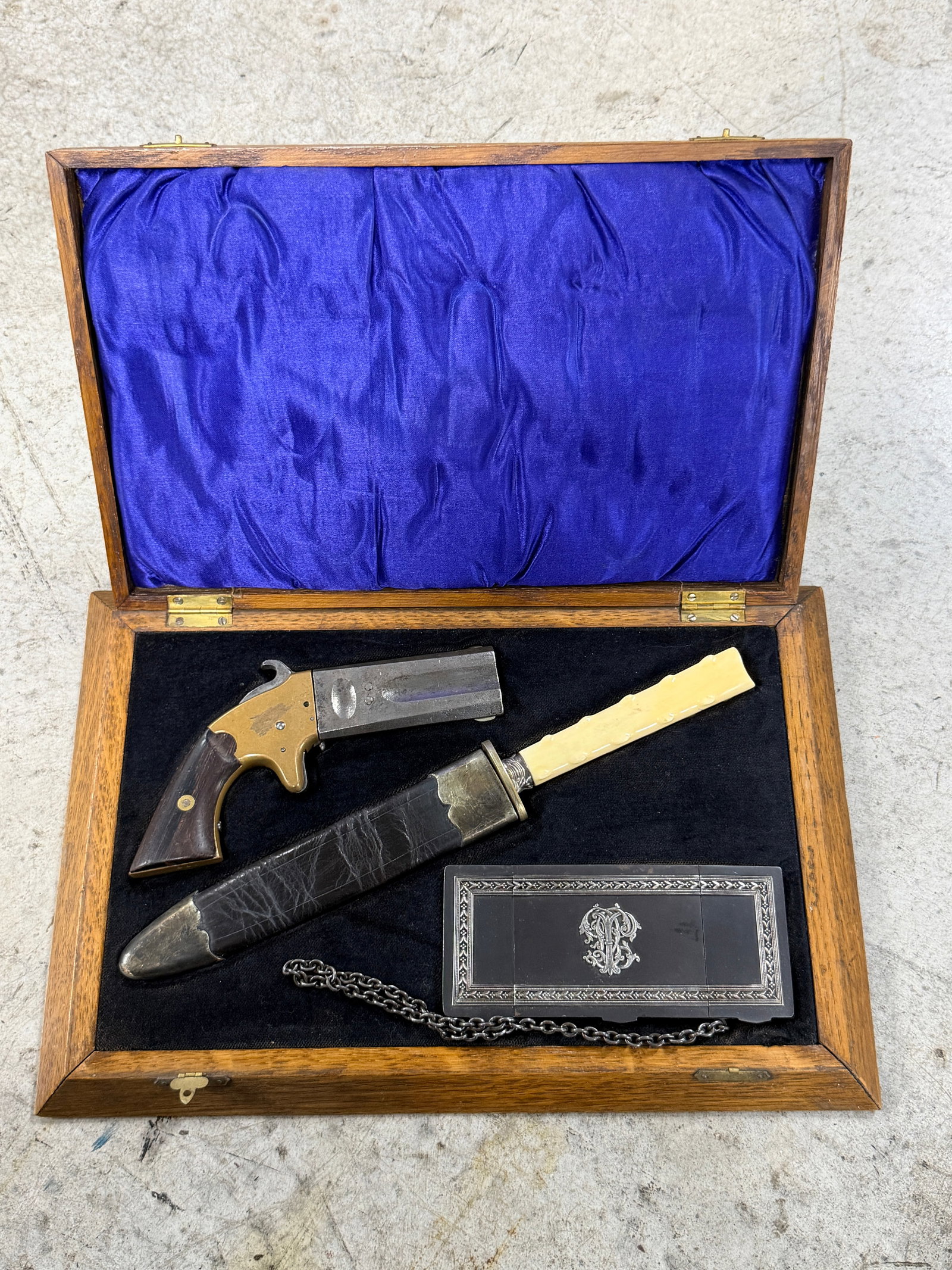 Civil War Tiffany & Co. Cased Derringer & Dagger Desk Set With Calling Card Case: An exceptionally attractive and unusual Victorian-era gentleman’s cased set featuring a single-shot derringer pistol, matching dagger with sheath, and ornate calling card case housed in a fitted har