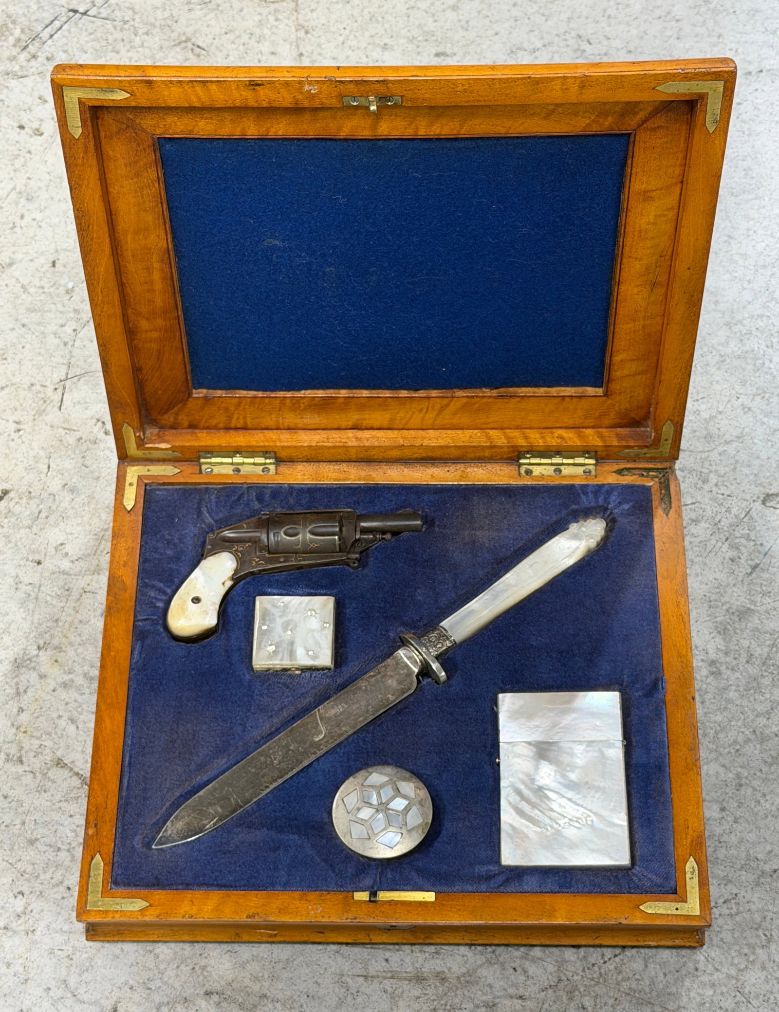 1800's Cased Gentleman’s Set Featuring Engraved Pocket Revolver, Mother-of-Pearl Handled Dagger,: An elegant and highly decorative Victorian-era gentleman’s cased ensemble featuring an engraved pocket revolver, finely crafted dagger, and several luxurious personal accessories housed in a fitted 