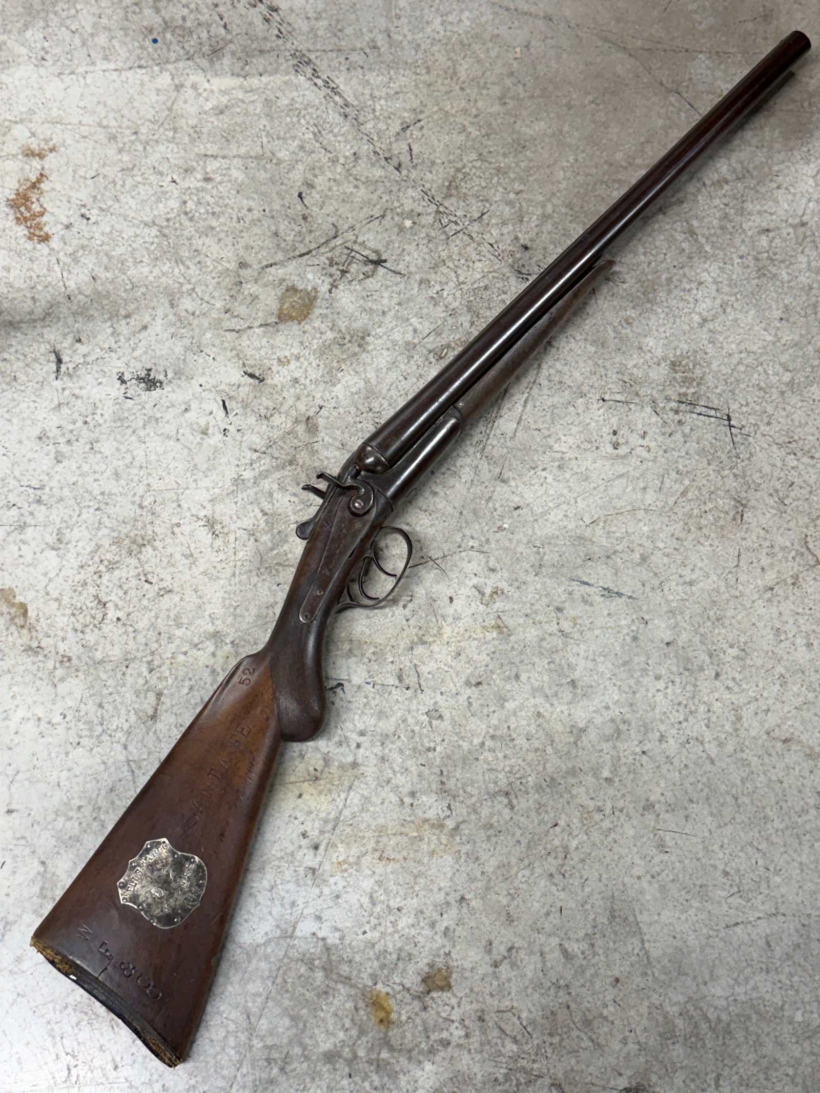 1891 Wells Fargo Express #52 Double Barrel Hammer Shotgun Marked “Santa Fe: Antique 1891 Wells Fargo Express double barrel hammer shotgun marked “Santa Fe” on the walnut buttstock and fitted with an original Wells Fargo Express shield plaque engraved “52 EXPRESS 18.