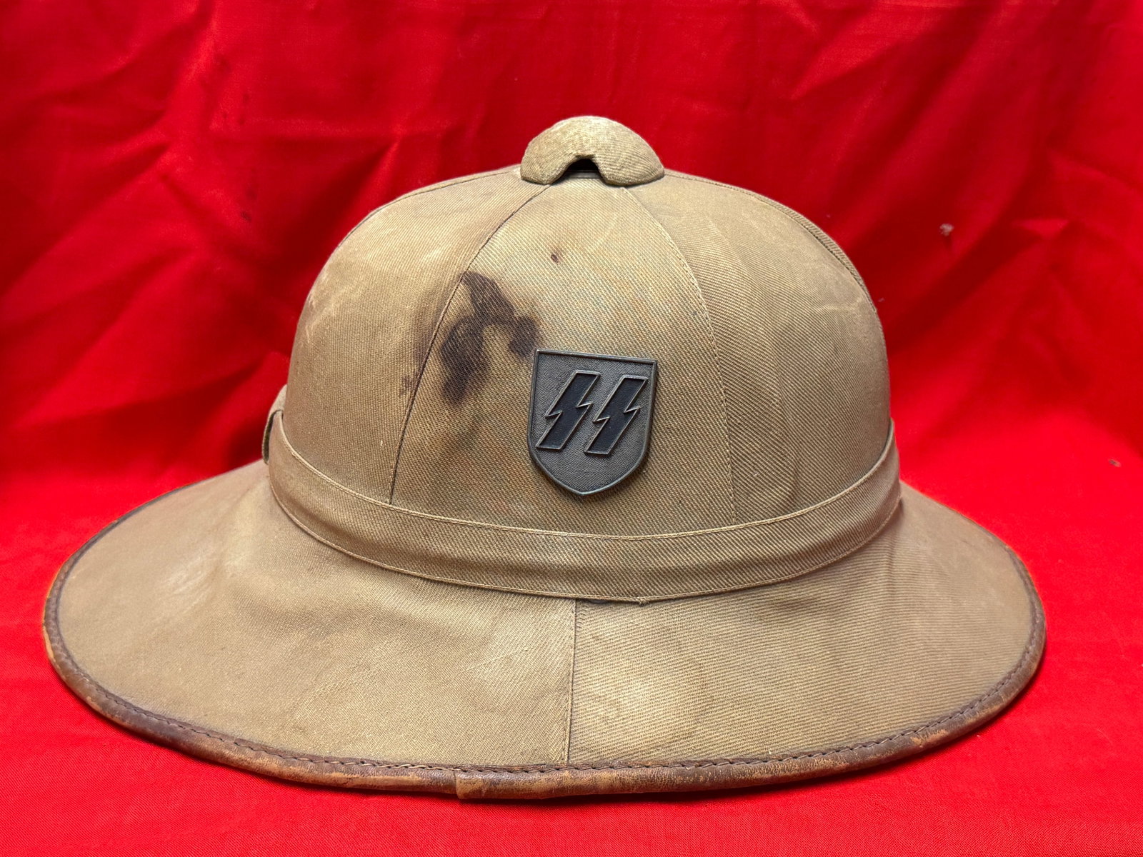 WWII German Waffen-SS Tropical Pith Helmet (Tropenhelm) – Pose Wehrausrüstungen: WWII German Waffen-SS tropical pith helmet (Tropenhelm) manufactured by Pose Wehrausrüstungen. This specialized tropical headgear was produced in limited quantities for Waffen-SS personnel serving in