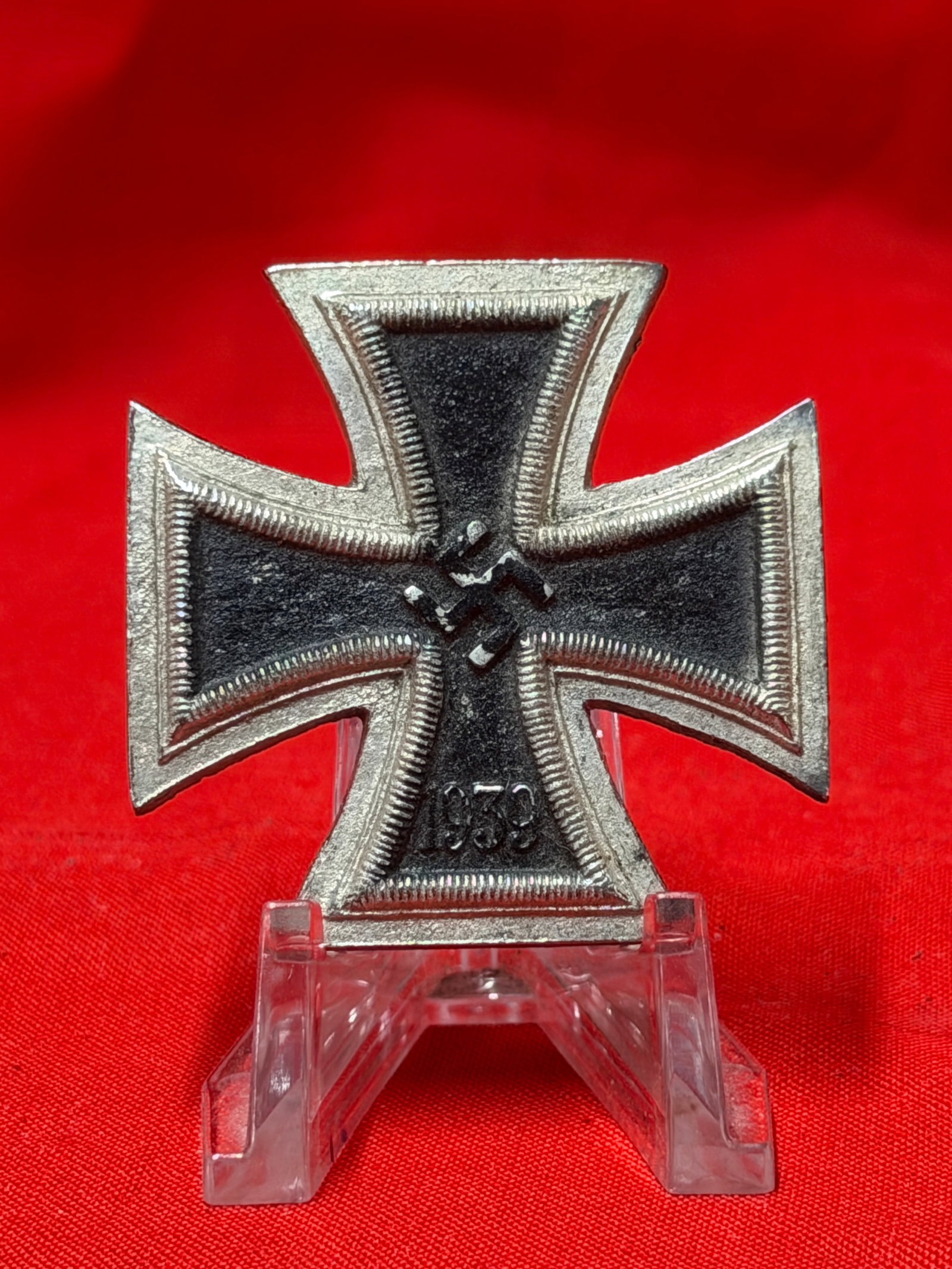WWII German Iron Cross Style 1939 Pinback Badge: WWII era German Iron Cross style pinback badge featuring black center with silver tone border, central swastika emblem, and “1939” date at the lower arm. Rear retains original style pinback at