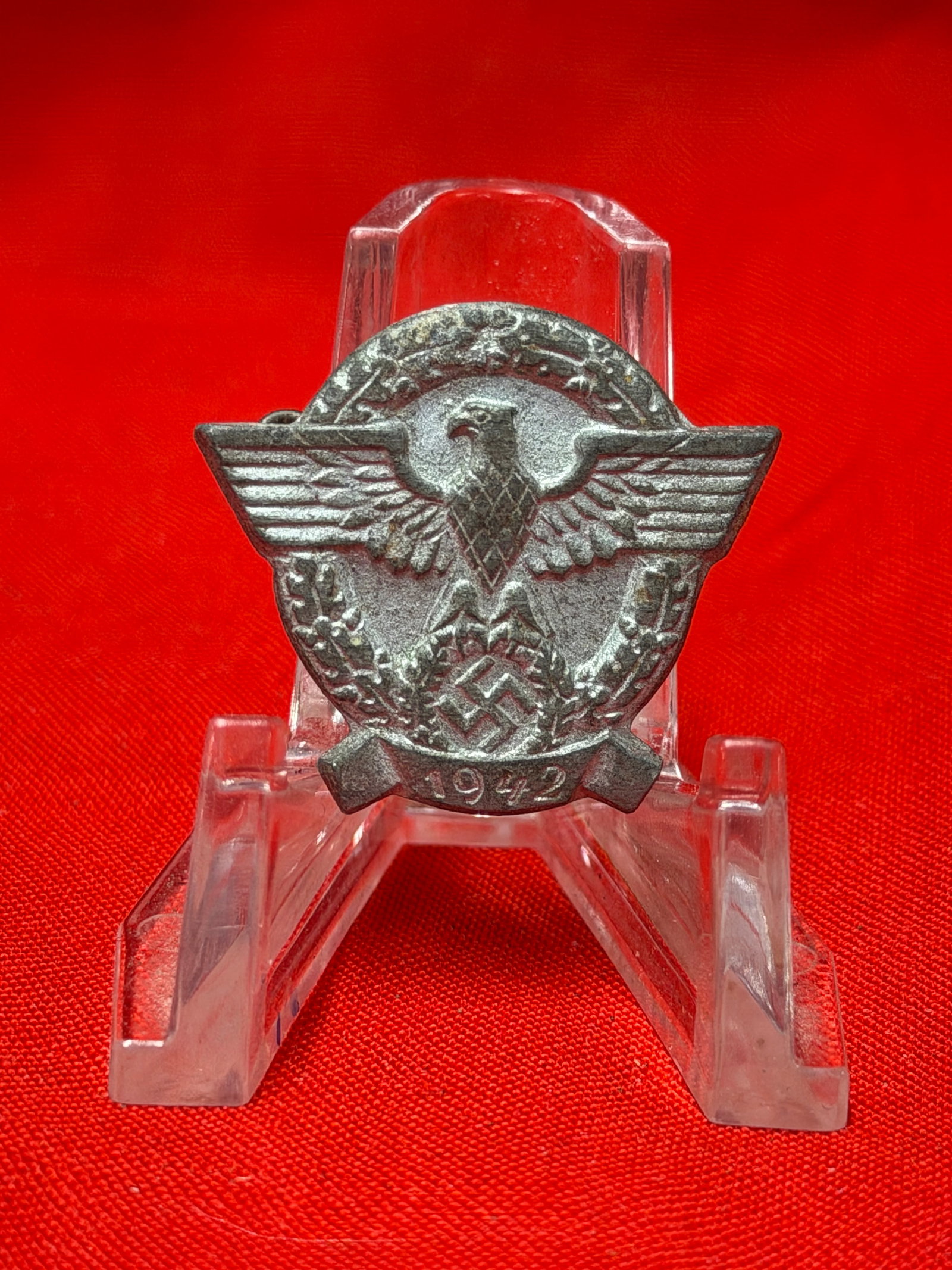 WWII German 1942 Tinnie Badge Political Rally Pin Marked “82: WWII era German tinnie style commemorative badge featuring national eagle over wreath and swastika emblem with “1942” date banner at the bottom. Reverse marked “82” with functional pin