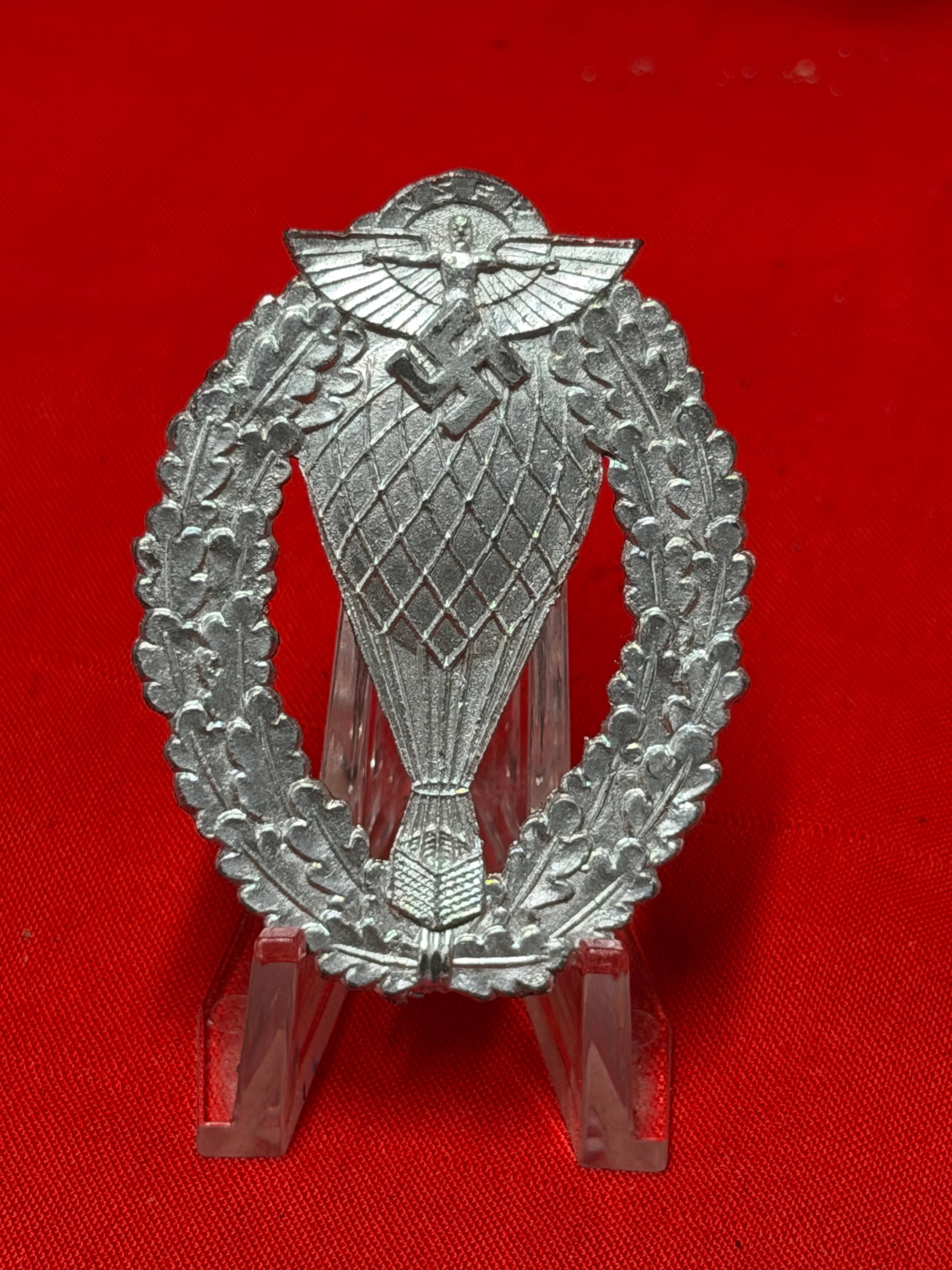 WWII German NSFK Balloon Pilot Badge – National Socialist Flyers Corps (NSFK) Pinback Award: WWII German NSFK Balloon Pilot Badge (Abzeichen für Freiballonführer) awarded to qualified balloon pilots of the National Socialist Flyers Corps (NSFK). The badge features a stylized balloon within 