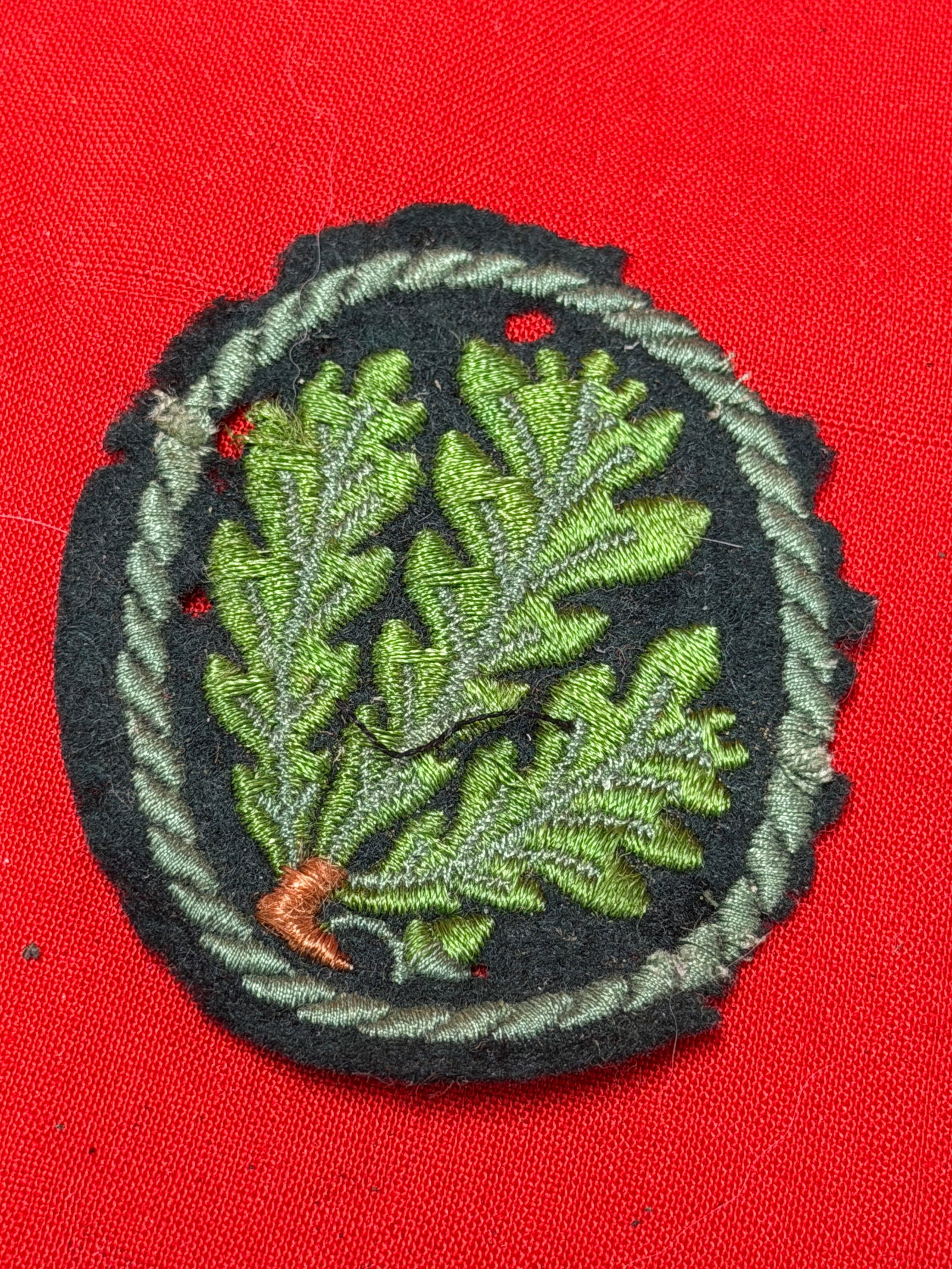 WWII German Forestry Service Oak Leaf Cloth Uniform Patch Badge: German forestry related embroidered cloth insignia featuring green oak leaf branch design on black wool backing with twisted border edge. In our opinion, this piece follows the World War II era German