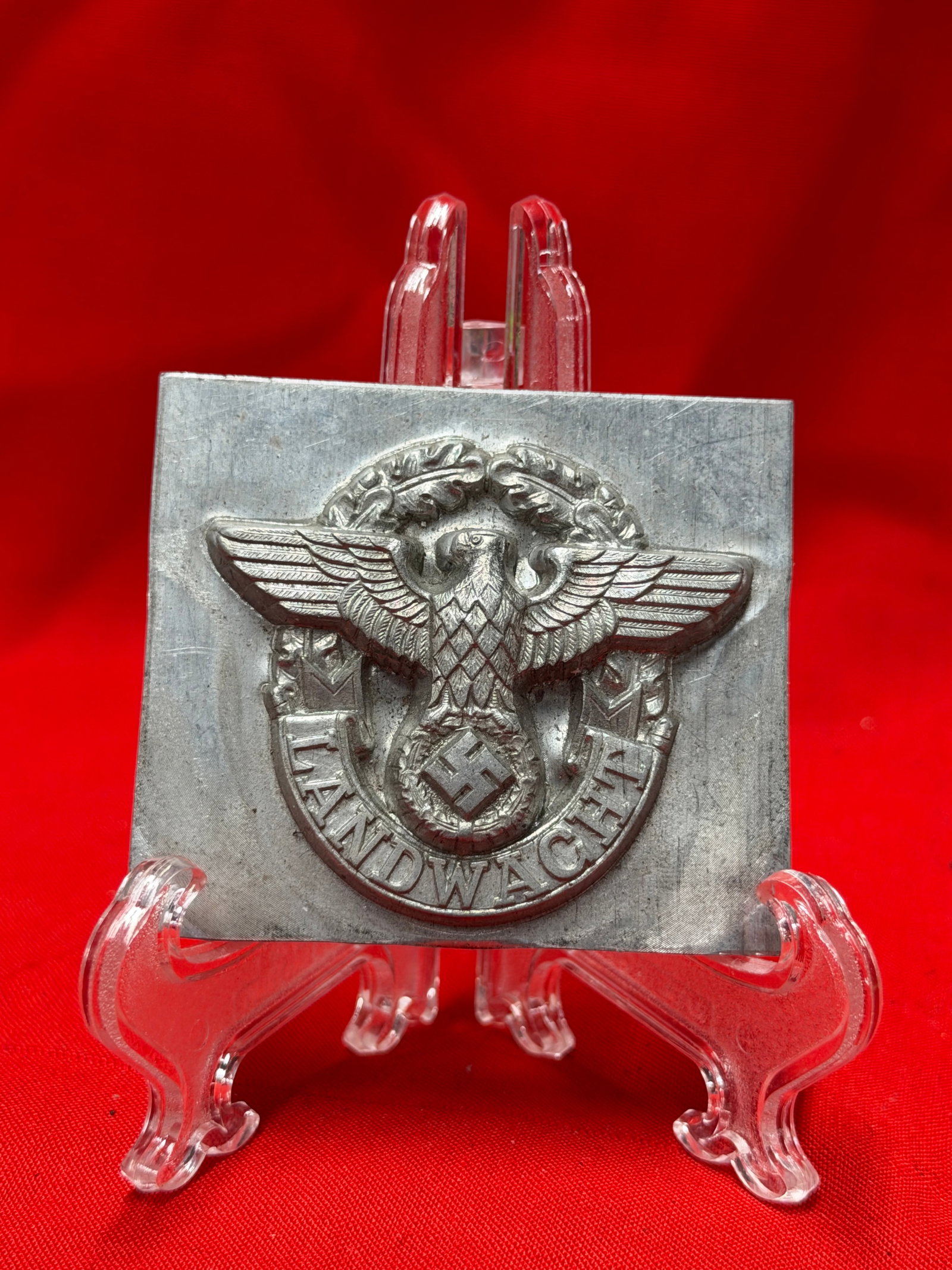 WWII German Landwacht Eagle Metal Uniform Stamp / Die Block: World War II era German “Landwacht” eagle and wreath insignia metal stamp or embossing die block featuring raised Reich eagle over swastika and “LANDWACHT” lettering. Heavy solid metal