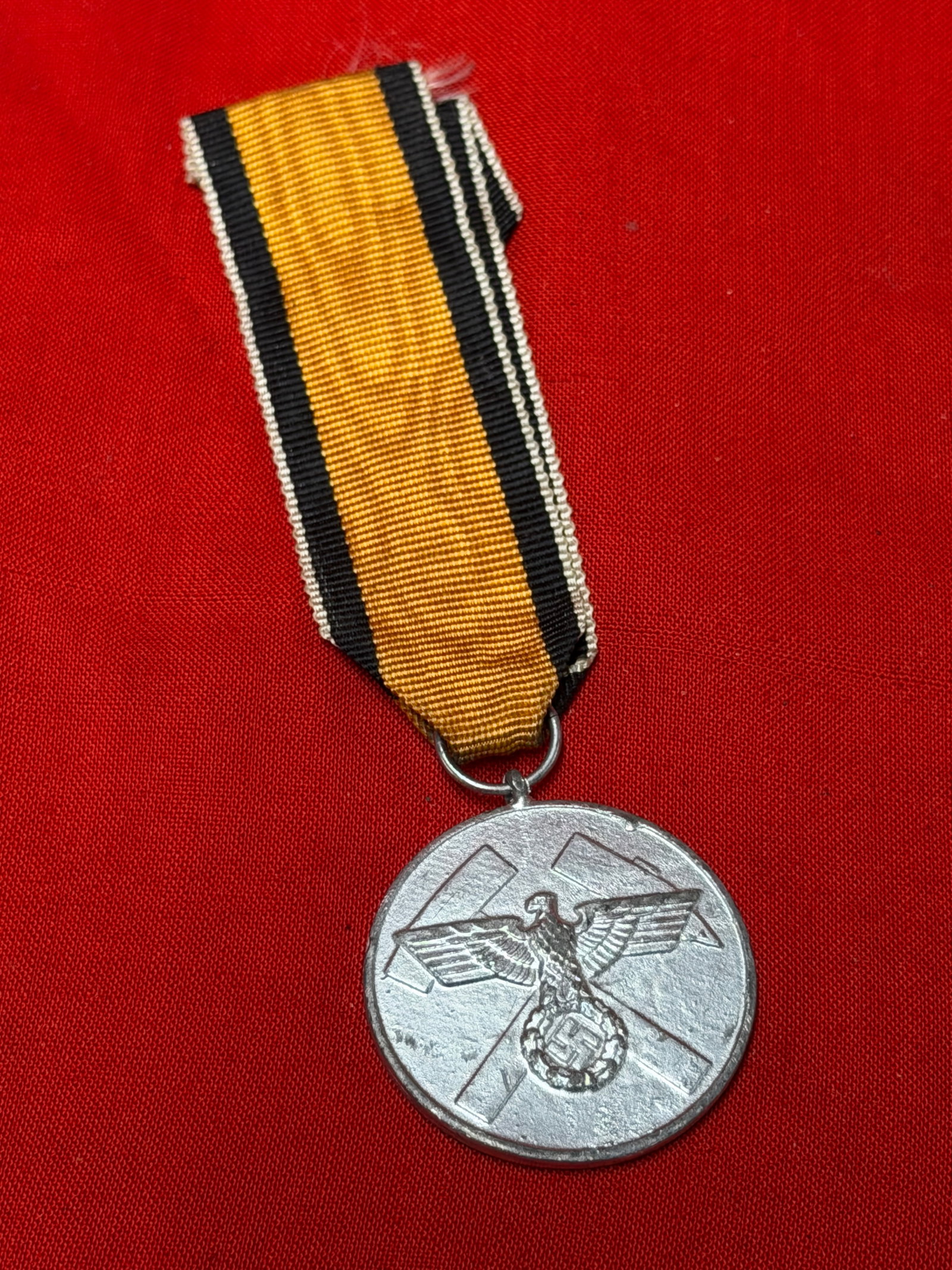 WWII German Mine Rescue Honour Medal Grubenwehr-Ehrenzeichen with Ribbon: WWII era German Mine Rescue Honour Medal (Grubenwehr-Ehrenzeichen) featuring National Eagle over crossed mining hammers to front. Reverse bears German inscription surrounded by oakleaf wreath. Include