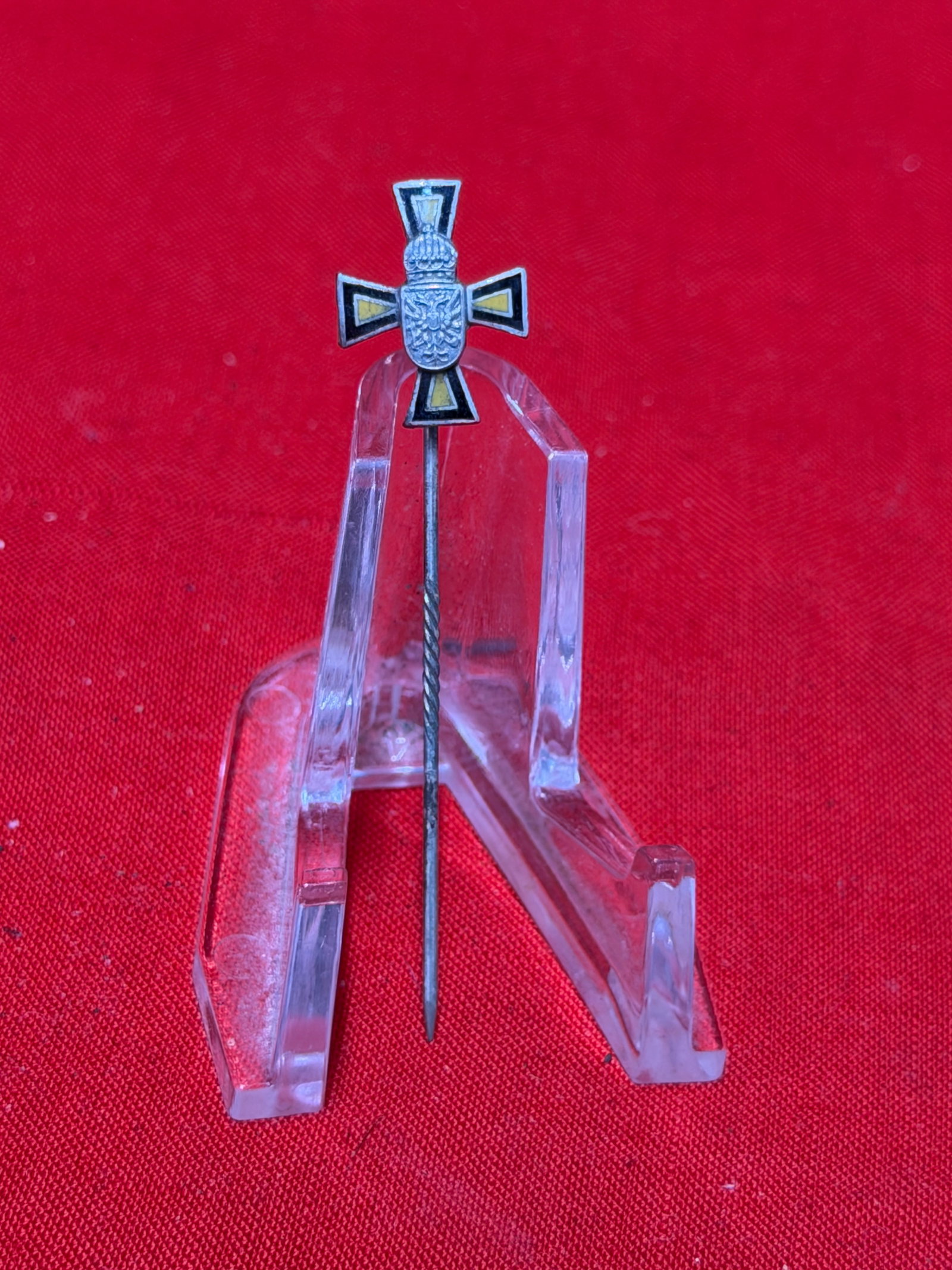 German Imperial Style Cross Stickpin with Crowned Shield Motif: German stickpin featuring an enameled cross design with central crowned shield emblem displaying a heraldic eagle motif. Constructed with black and yellow enamel accents and long twisted pin shaft typ