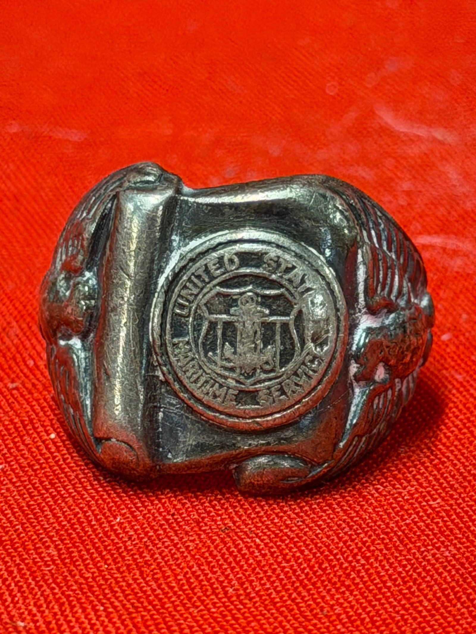 WWII United States Maritime Service Sterling Silver Ring Eagle Anchor Military Band: Vintage World War II era United States Maritime Service ring featuring raised circular “UNITED STATES MARITIME SERVICE” emblem with anchor centerpiece and detailed eagle designs along both sid