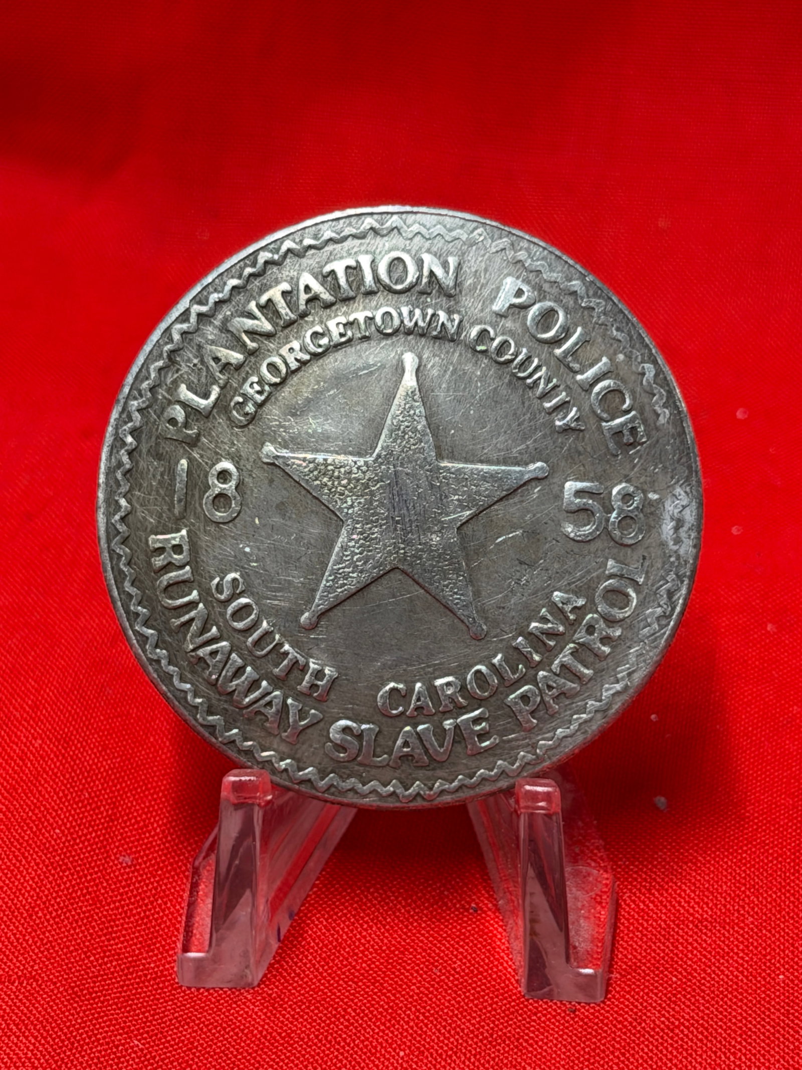 Plantation Police Georgetown County South Carolina Slave Patrol Badge 1858 Pin Back Badge: Plantation Police Georgetown County South Carolina “Slave Patrol” badge dated 1858 featuring large center star design with raised lettering and pin back attachment on reverse. In our opinion t