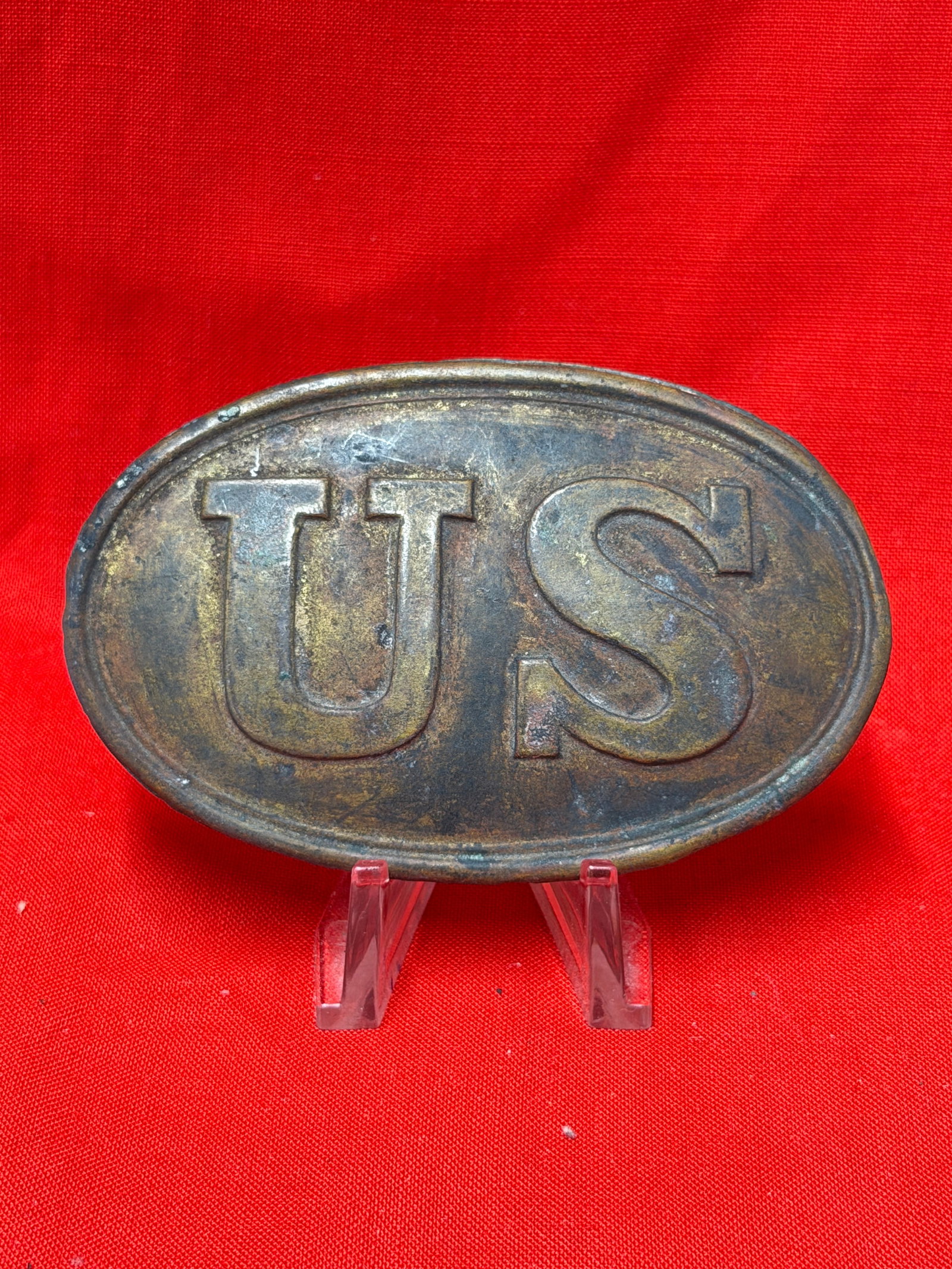 Civil War Era US Cartridge Box Plate Brass Oval Plate With Lead Filled Back: Oval brass US cartridge box plate with raised US lettering and lead filled reverse with wire attachment hooks present. In our opinion this piece represents a Civil War era cartridge box plate used on 