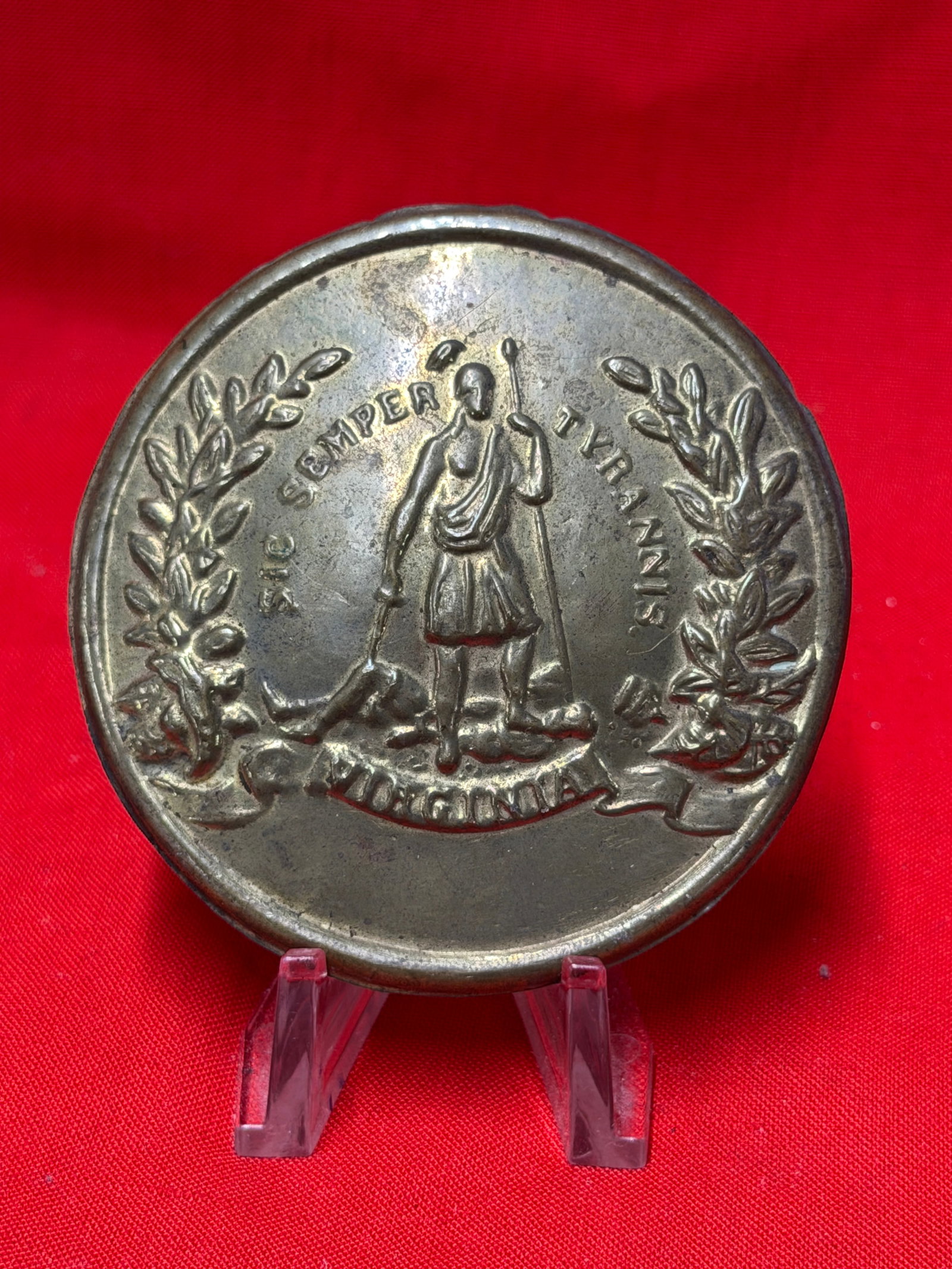 Civil War Era Virginia State Seal Cartridge Box Plate Brass Militia Plate: Round brass Virginia state seal cartridge box plate featuring standing figure with “Sic Semper Tyrannis” motto and lead filled reverse with attachment hooks present. In our opinion this piece 