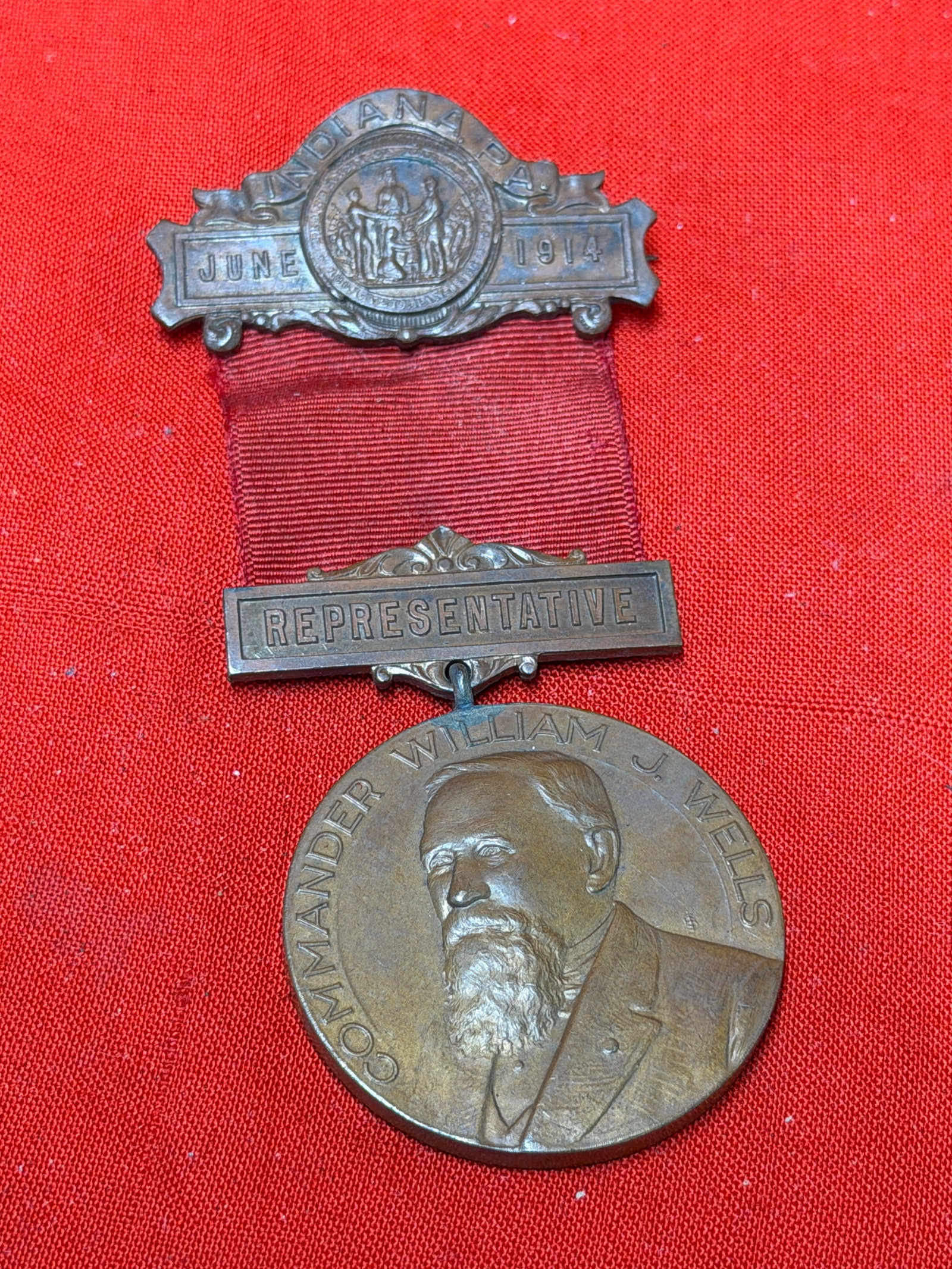 1914 Indiana G.A.R. Representative Medal – Commander William J. Wells Encampment Badge: 1914 Grand Army of the Republic (G.A.R.) representative delegate medal from the Indiana Department Annual Encampment. Features an ornate top bar reading “Indiana Pa.” with central GAR emblem a