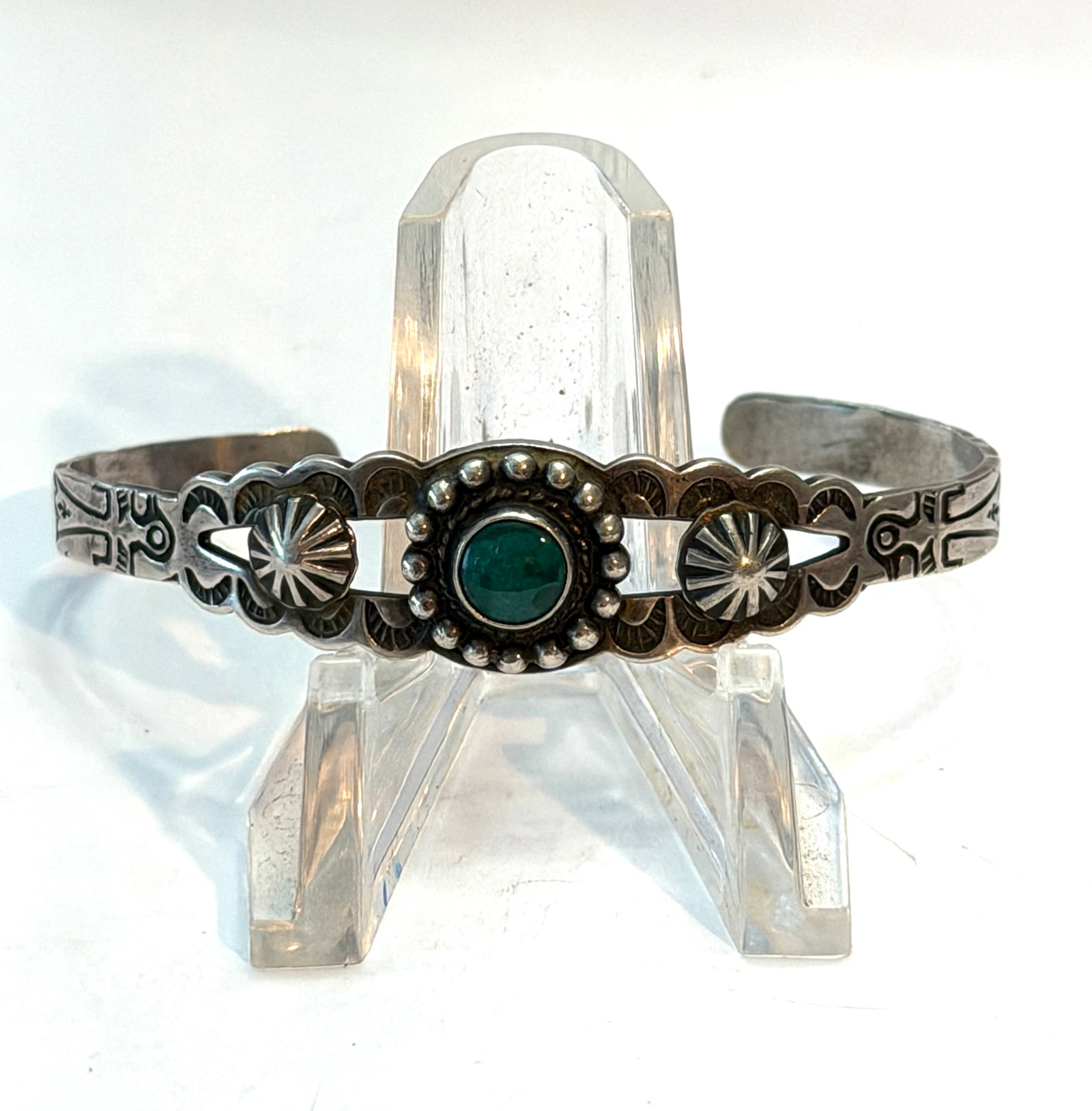 Native American Sterling Silver Turquoise Cuff Bracelet Hand Stamped Southwestern: Vintage Native American sterling silver cuff bracelet featuring a central green turquoise stone surrounded by detailed silver beadwork and classic Southwestern stamp designs. The cuff showcases hand-s