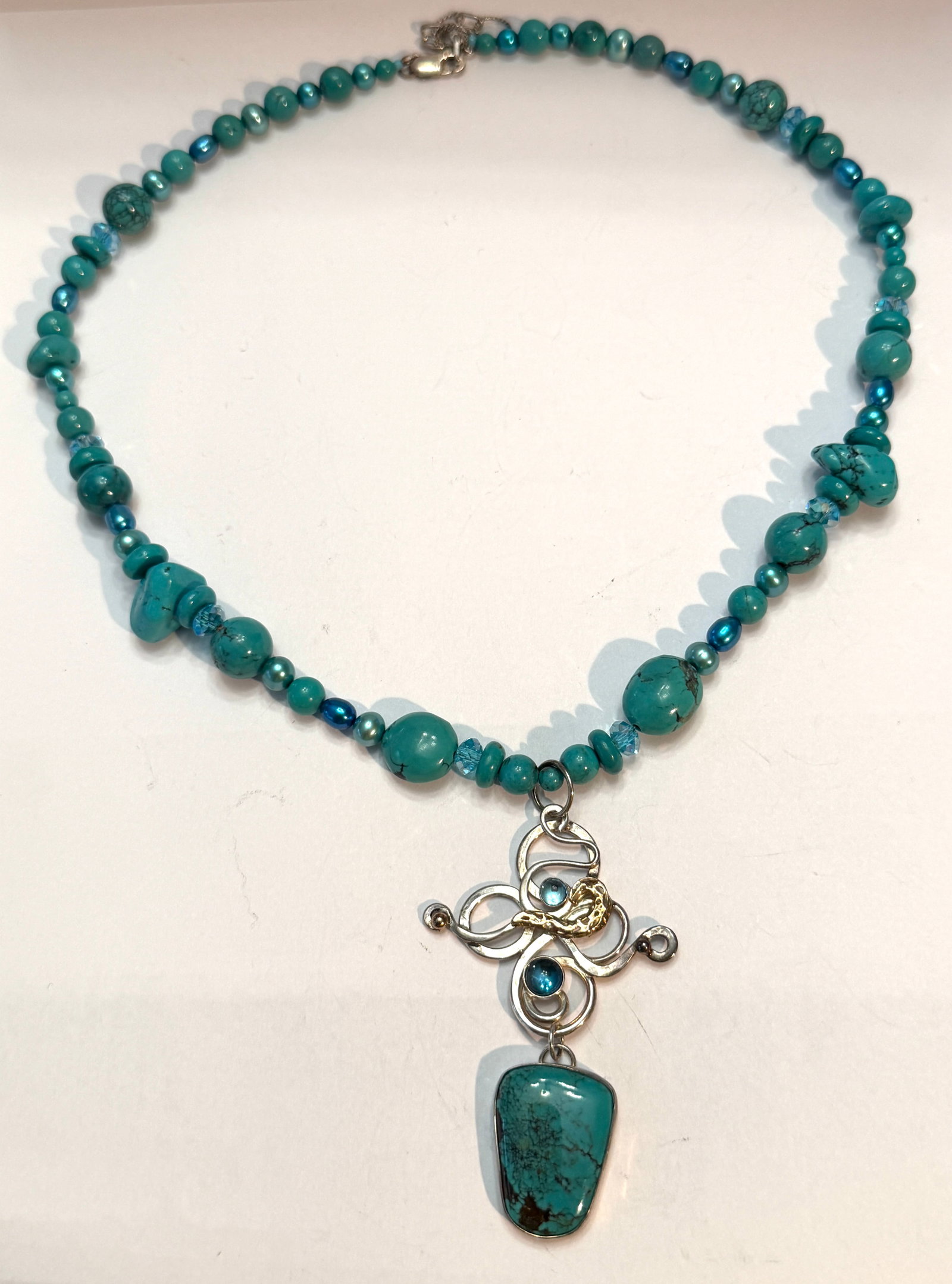 Relesica Sterling Silver 14K Gold Turquoise Necklace Signed Artisan Pendant: Beautiful signed Relesica turquoise bead necklace featuring a handcrafted sterling silver and 14K gold pendant with flowing swirl design, bezel set blue stones, and a large turquoise drop centerpiece.