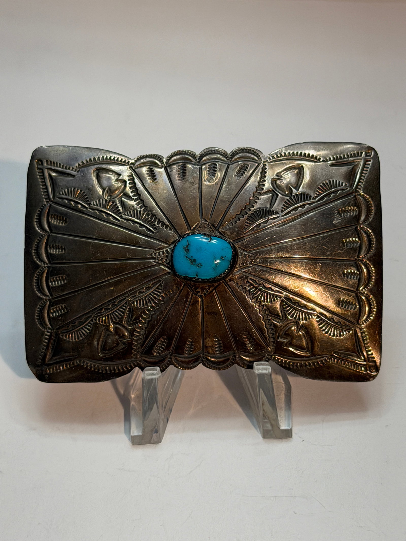 Southwestern Sterling Silver Turquoise Concho Style Belt Buckle: Classic vintage Southwestern sterling silver belt buckle featuring a striking natural turquoise cabochon centerpiece surrounded by bold hand-stamped sunburst and fan motifs. The buckle displays tradit