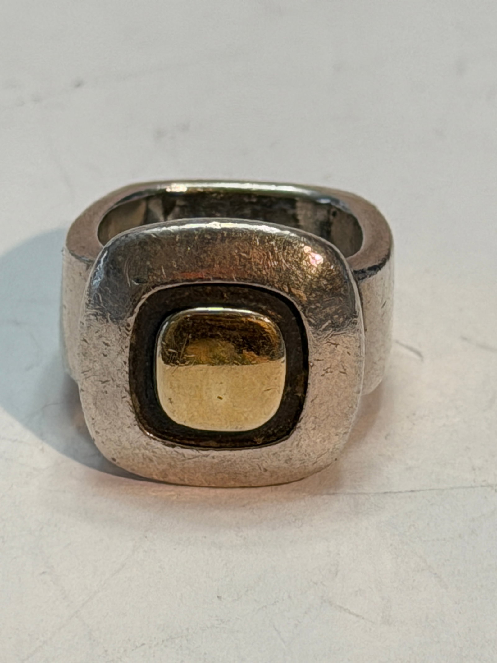 Modernist Sterling Silver & 14K Gold Geometric Ring by Zina ? Size 5: Bold modernist ring by Zina crafted in sterling silver with a raised 14K gold geometric center accent. This chunky designer statement ring features a clean architectural design with a wide band and mi