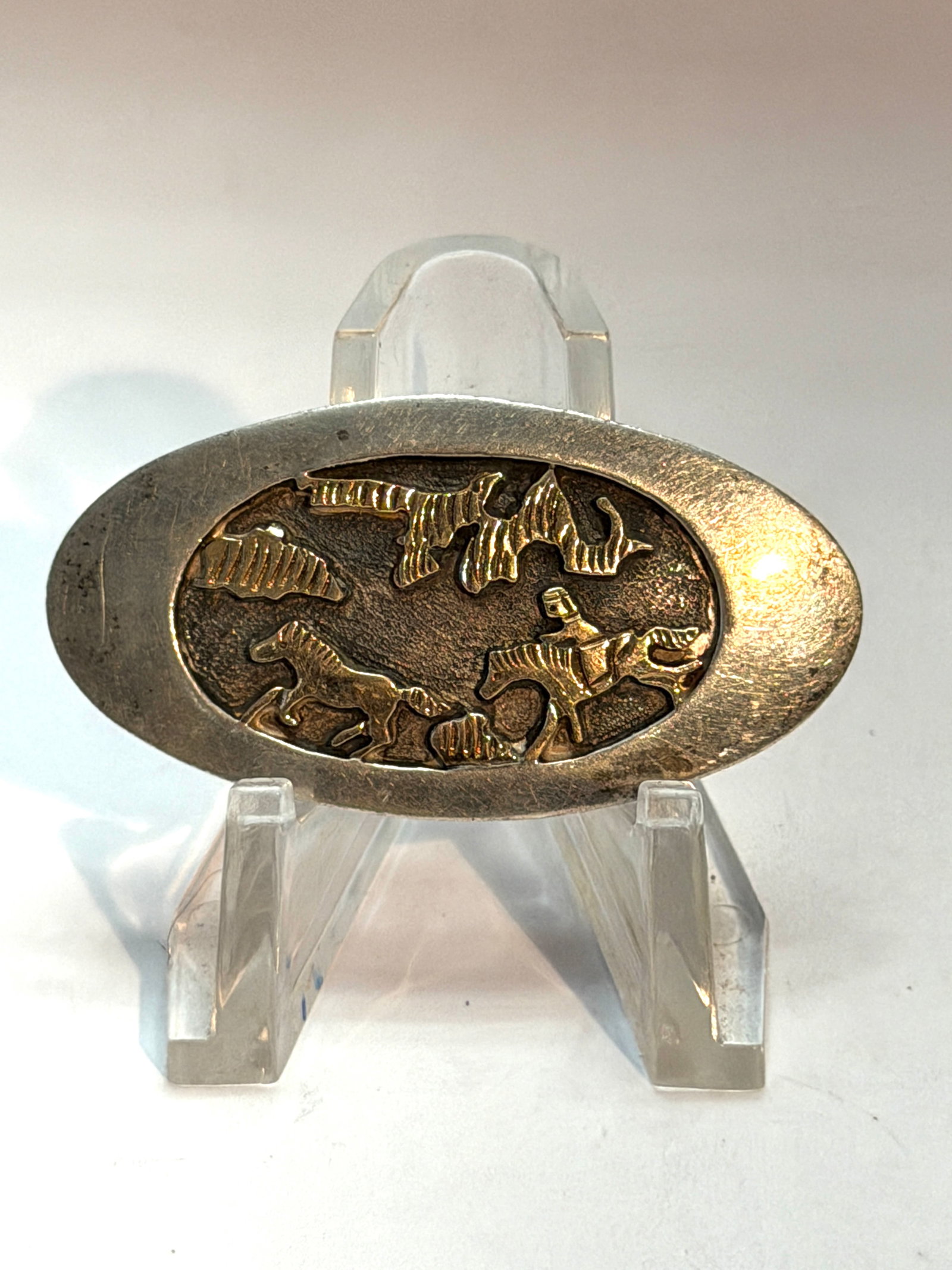 14K Gold Overlay Western Horse & Rider Brooch ? Southwestern Figural Pin Marked HY: Vintage oval brooch featuring a raised Western scene with horses, rider, and mountain landscape in contrasting mixed metals. The piece appears to be sterling silver with 14K gold overlay accents, mark