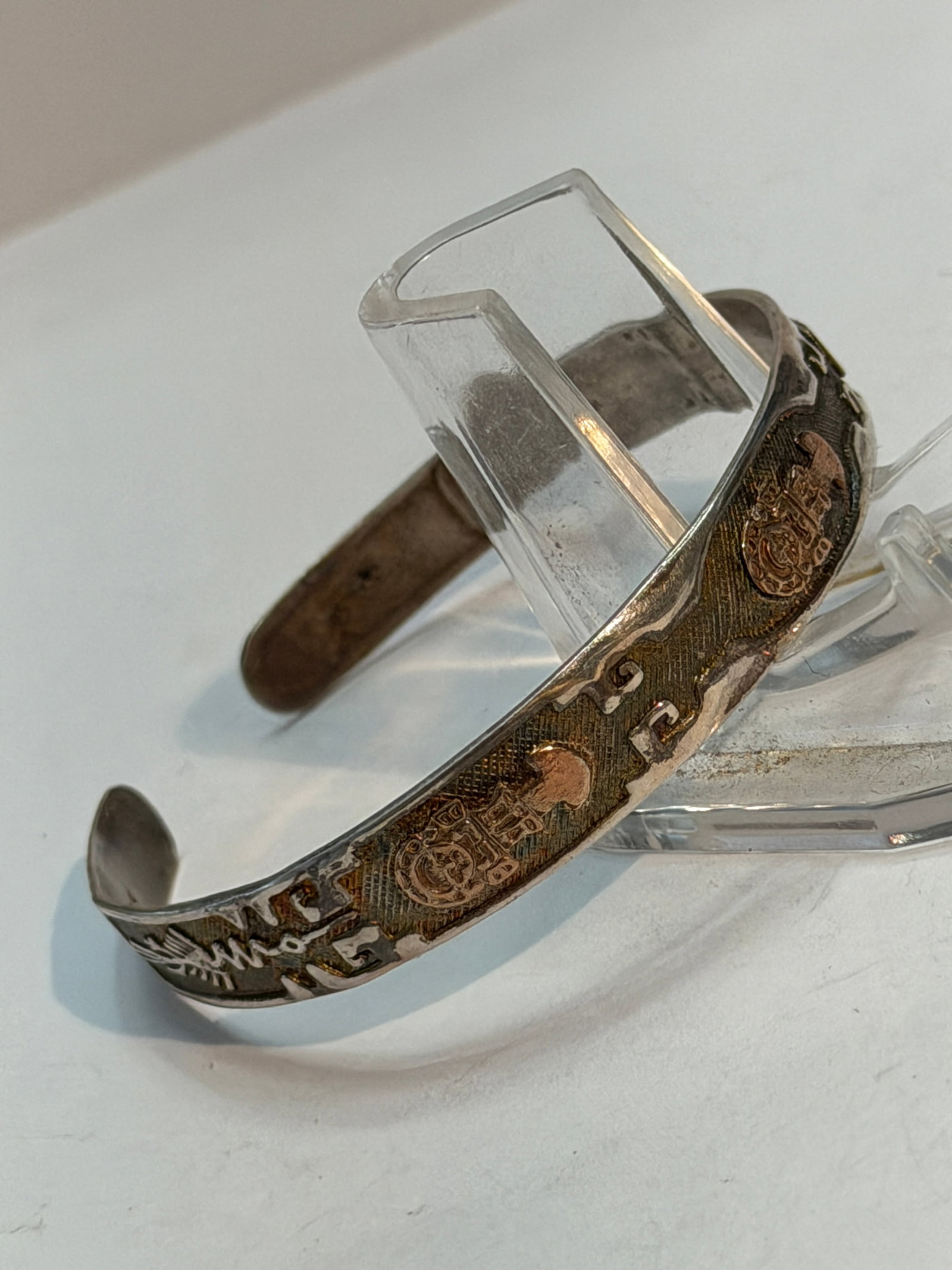 Vintage Southwestern Sterling Silver & 18K Gold Kokopelli Cuff Bracelet: Southwestern sterling silver cuff bracelet with 18K gold overlay accents featuring Kokopelli figures, geometric symbols, and Native-inspired etched designs. Marked “18K” inside the cuff. T