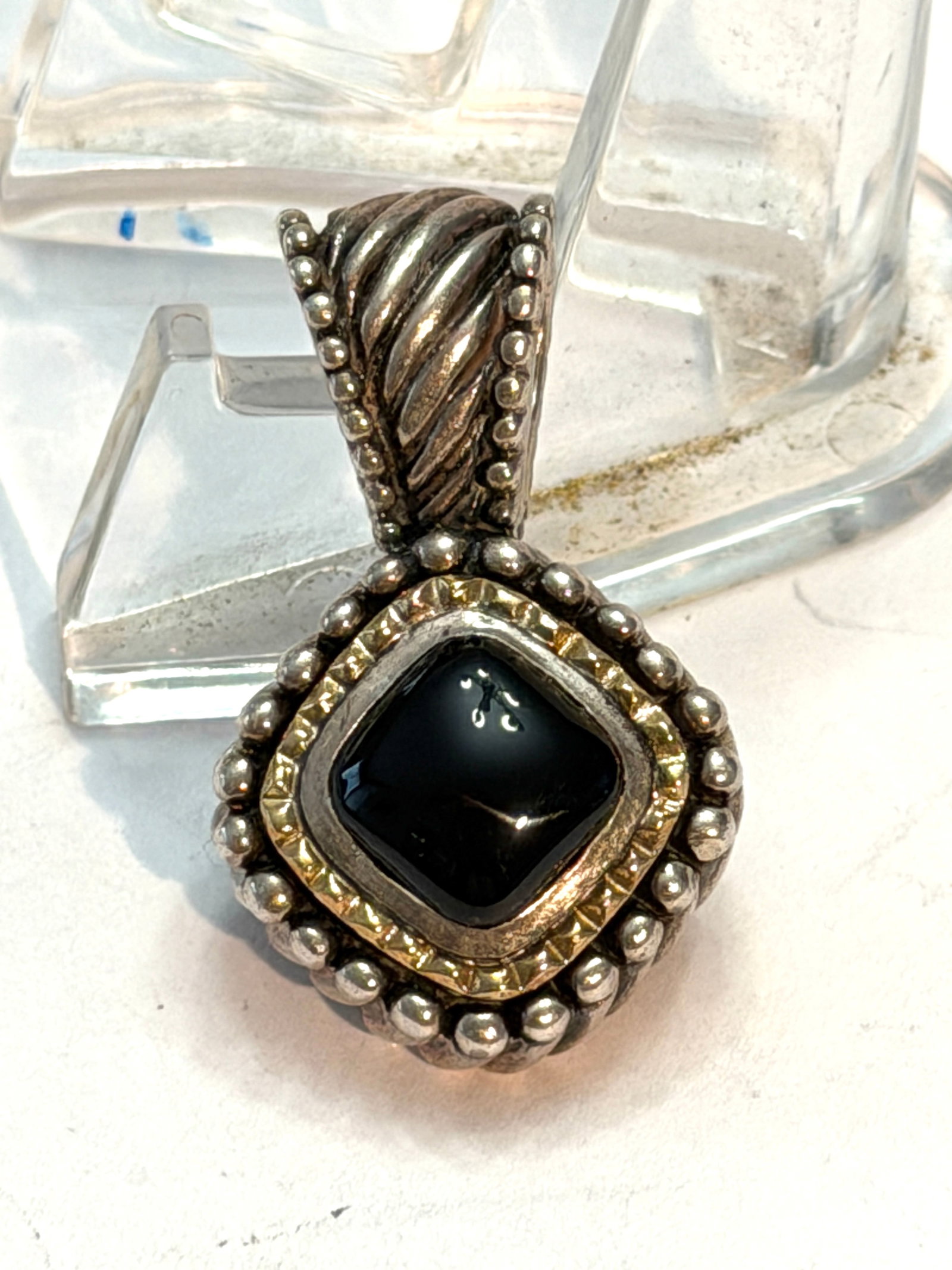 Vintage Sterling Silver & 18K Gold Black Onyx Pendant Signed Italy Taxco Style: Vintage sterling silver pendant featuring a polished black onyx stone accented with 18K gold details in an ornate beaded setting with decorative ribbed enhancer bale. Signed “Italy” and ma