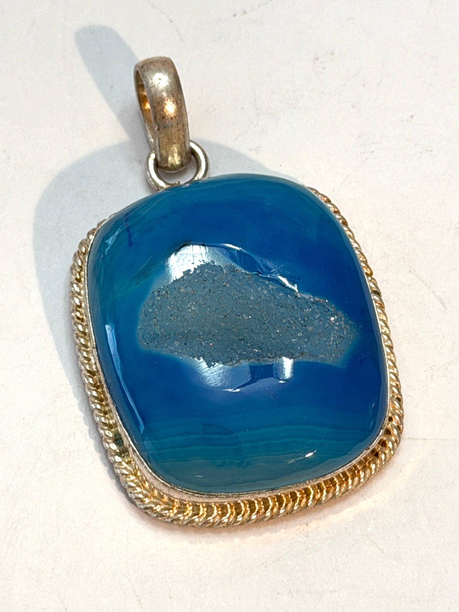 Designer Sterling Silver Blue Druzy Agate Pendant: Vintage sterling silver pendant featuring a vibrant blue banded agate cabochon with a natural sparkling druzy quartz center. The bold cushion-shaped stone displays rich ocean blue tones with subtle na