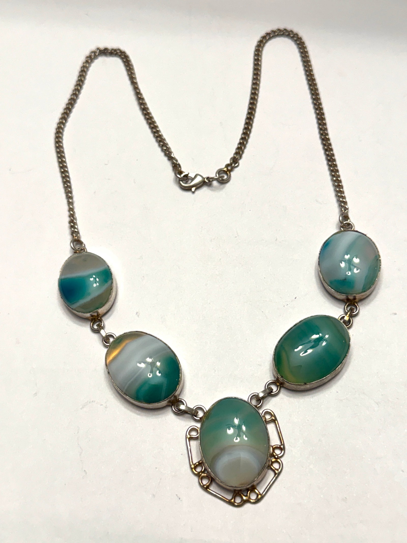 Vintage Sterling Silver Banded Green Blue Agate Necklace: Vintage sterling silver necklace featuring five oval banded agate cabochons in beautiful shades of seafoam green, aqua blue, and milky white. Each polished stone displays unique natural banding and is