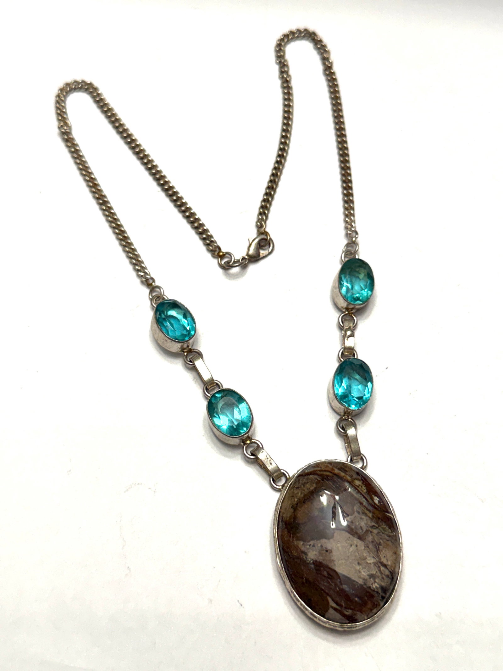 Sterling Silver Blue Topaz & Jasper Artisan Necklace Handmade Modernist Necklace: A stunning vintage artisan-crafted sterling silver necklace showcasing brilliant faceted blue topaz-colored gemstones paired with a dramatic natural jasper centerpiece. This elegant statement piece fe