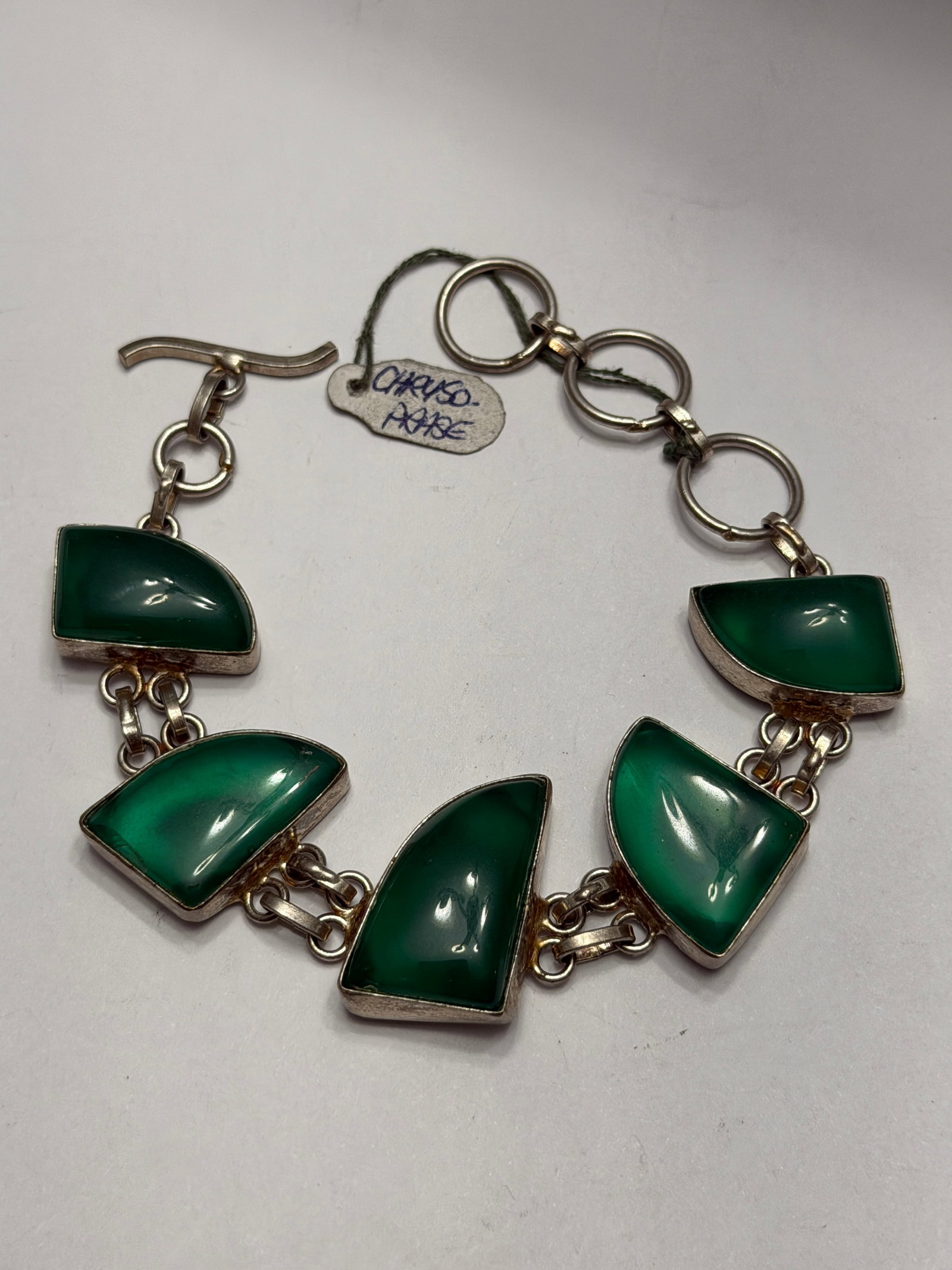 Vintage Sterling Silver Green Chrysoprase Link Bracelet: A striking vintage sterling silver bracelet featuring rich green chrysoprase cabochons in an elegant geometric modernist design. This eye-catching statement piece showcases five beautifully polished c