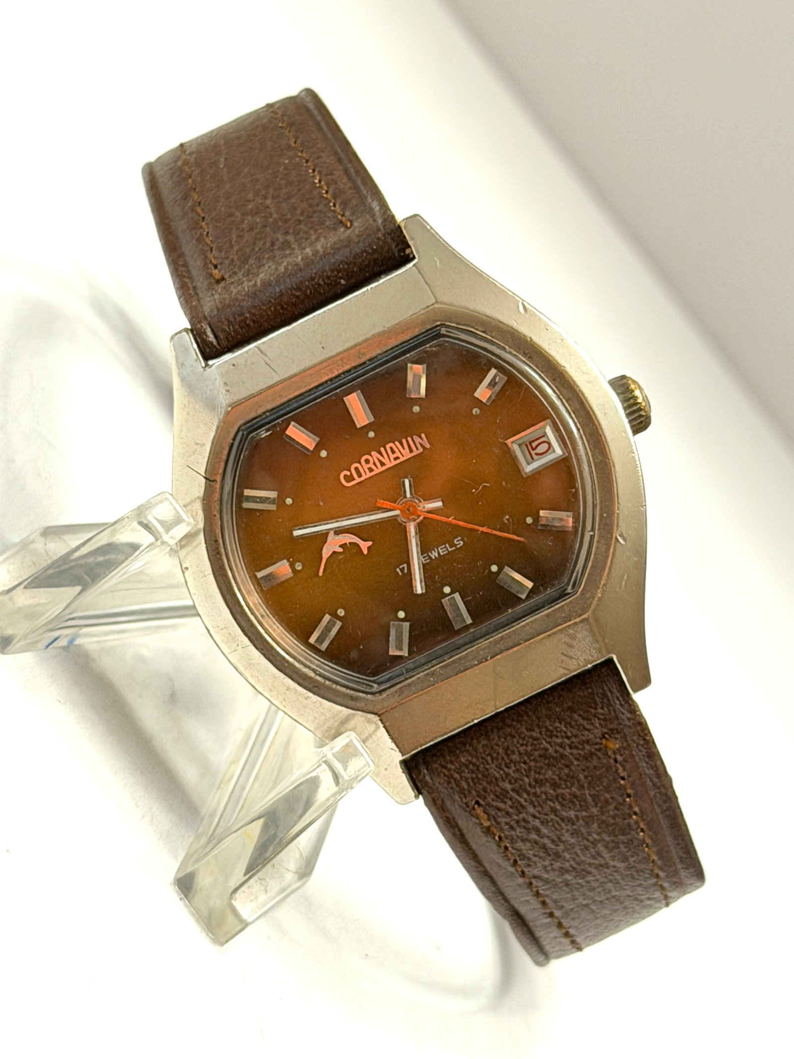 Vintage Cornavin Pentaflex 17 Jewels Date Wristwatch Brown Dial Leather Strap: Classic vintage Cornavin Pentaflex wristwatch featuring a distinctive retro cushion-shaped case and rich brown sunburst dial with silver-tone hour markers and orange accents. This 17 jewels mechanical