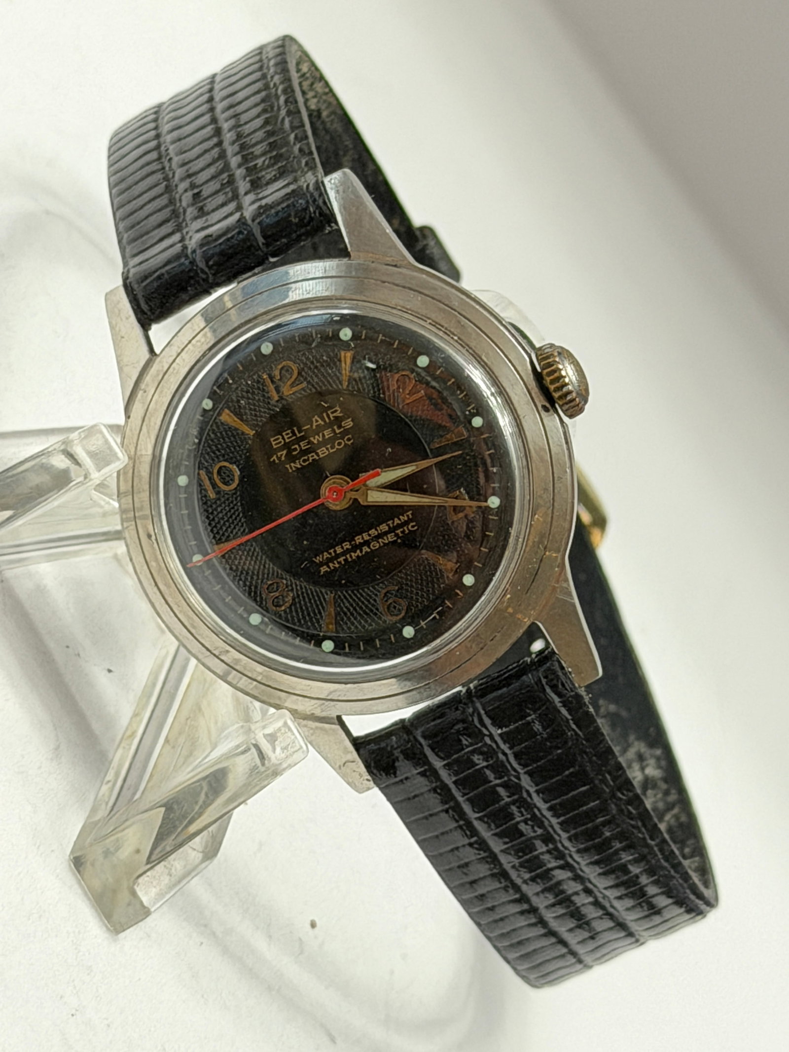 Bel-Air Incabloc 17 Jewels Mechanical Wristwatch ? Black Textured Dial: Bel-Air mechanical wristwatch featuring a striking black textured dial with gold-tone Arabic numerals, luminous hour markers, and a bold red seconds hand. Powered by a 17-jewel movement with Incabloc 