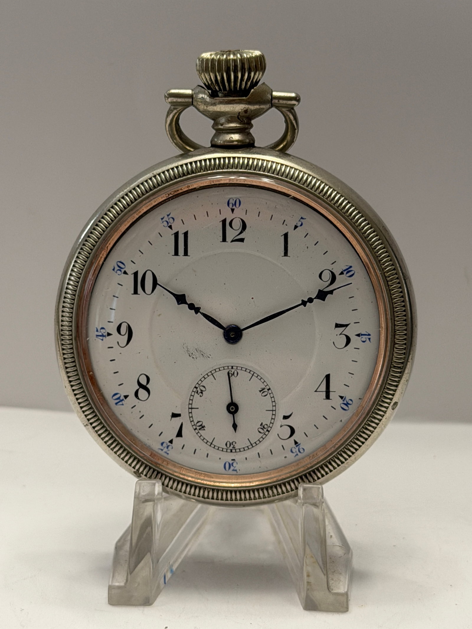 Ingersoll Triumph 15-Jewel Pocket Watch ? Open Face Mechanical Watch w/ Sub Seconds ? Vintage: Vintage Ingersoll “Triumph” open-face pocket watch featuring a clean white enamel-style dial with black Arabic numerals, blue outer minute markers, ornate blued hands, and a sub-seconds di