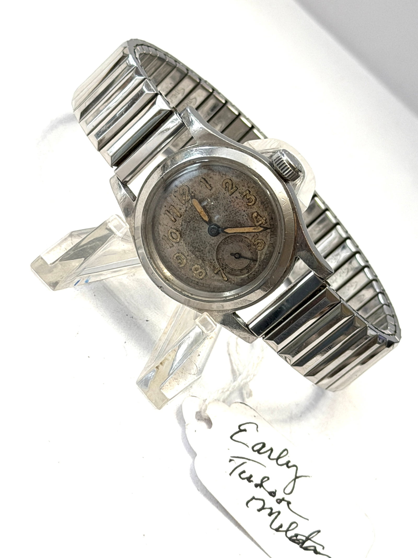 Vintage Oyster Watch Co. Swiss Manual Wind Wristwatch ? Tudor Movement: Vintage Oyster Watch Co. Swiss-made manual wind wristwatch featuring a classic aged tropical-style dial with large Arabic numerals, blued hands, and small seconds subdial at 6 o’clock. Stainless