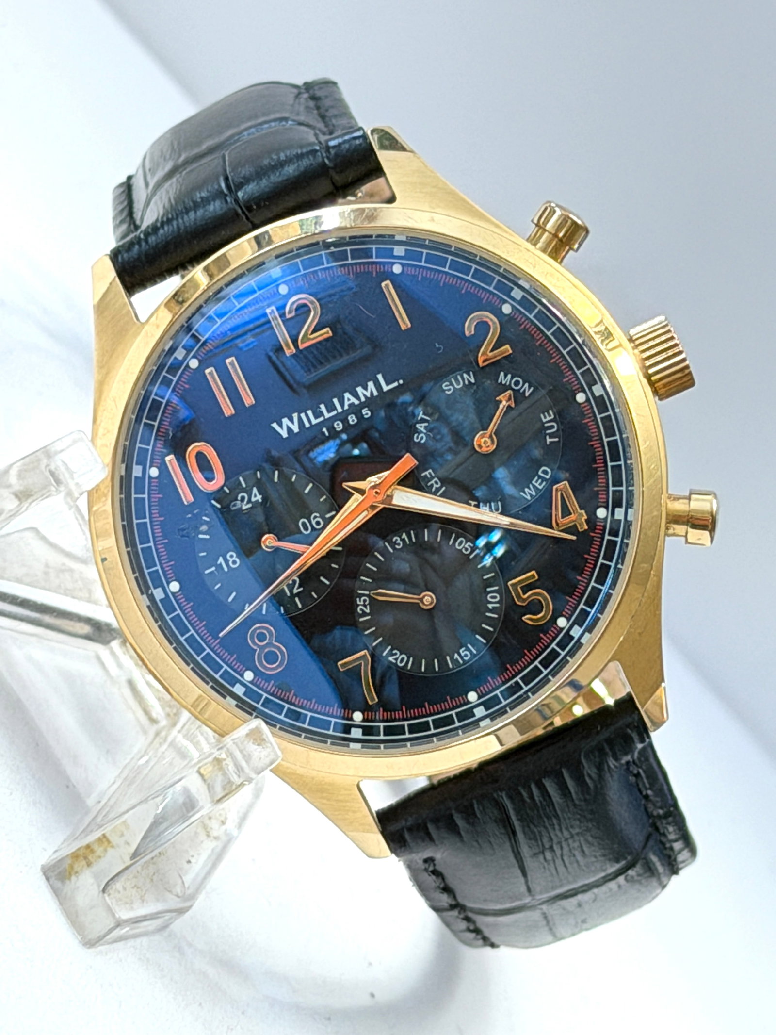 William L. 1985 Multi-Function Quartz Wristwatch: William L. 1985 multi-function quartz wristwatch featuring a gold-tone stainless steel case, black dial with rose gold-tone numeral markers, and multiple subdials displaying day, 24-hour, and date fun