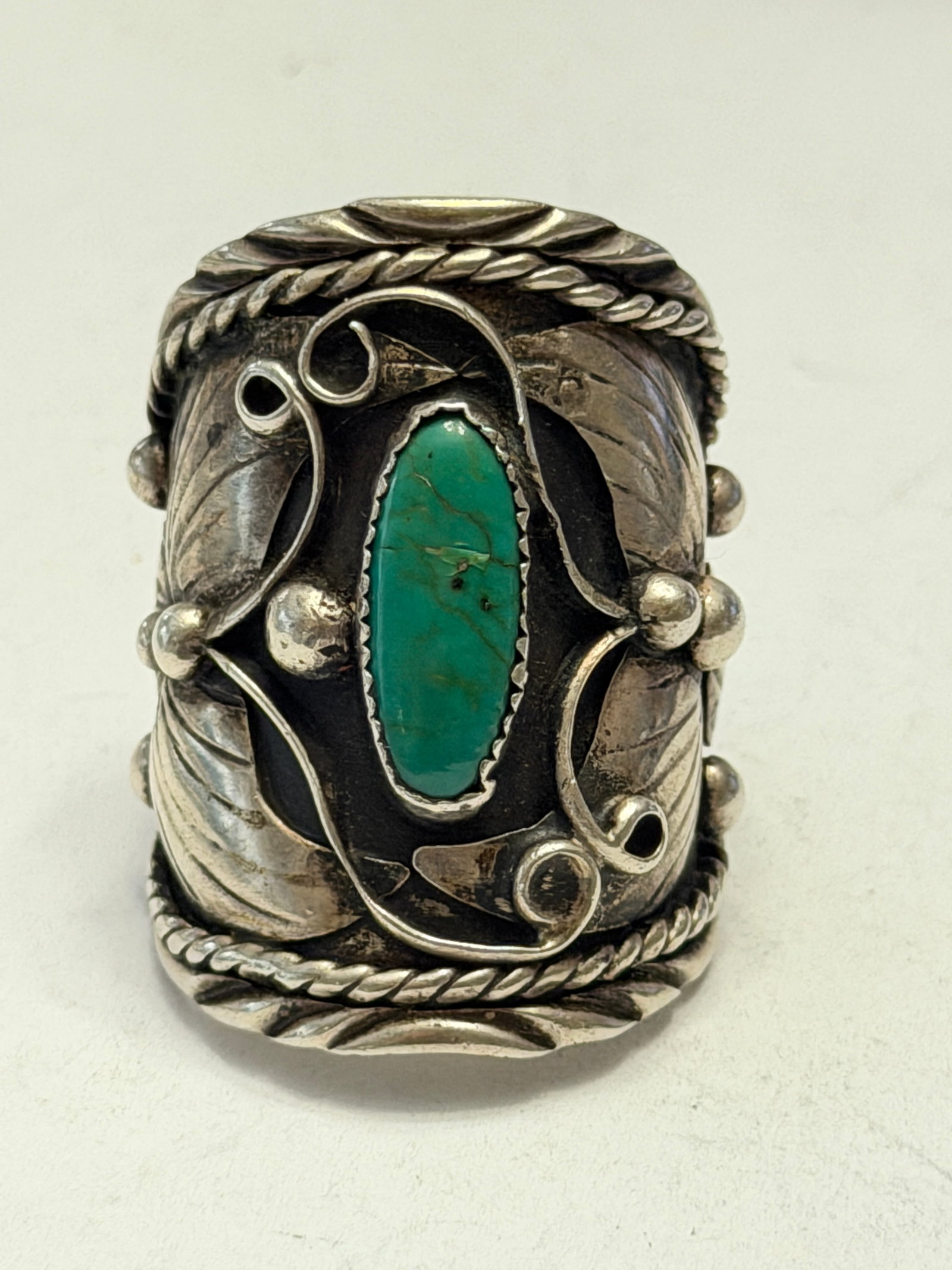 Native American Sterling Silver Turquoise Cuff Ring ? Size 15 ? Handmade Southwestern Statement Ring: Large vintage Native American or Southwestern-style sterling silver cuff ring featuring an elongated green turquoise cabochon set in a serrated bezel. The ring showcases detailed handcrafted silverwor