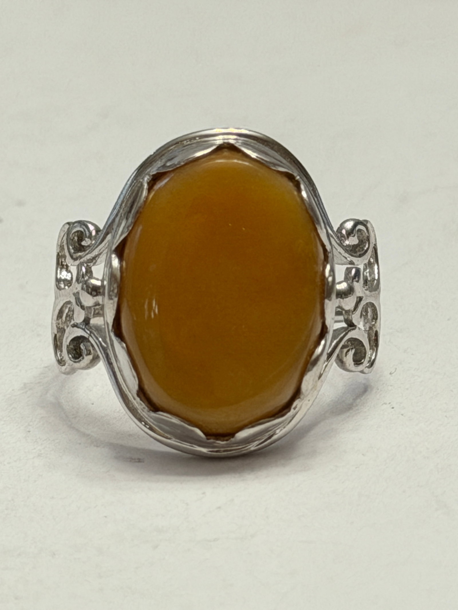 Sterling Silver Butterscotch Amber Style Filigree Ring Size 9: Vintage-inspired sterling silver statement ring featuring a large oval cabochon in a warm butterscotch honey amber tone. The ornate openwork filigree shoulders and scalloped bezel setting give the pie