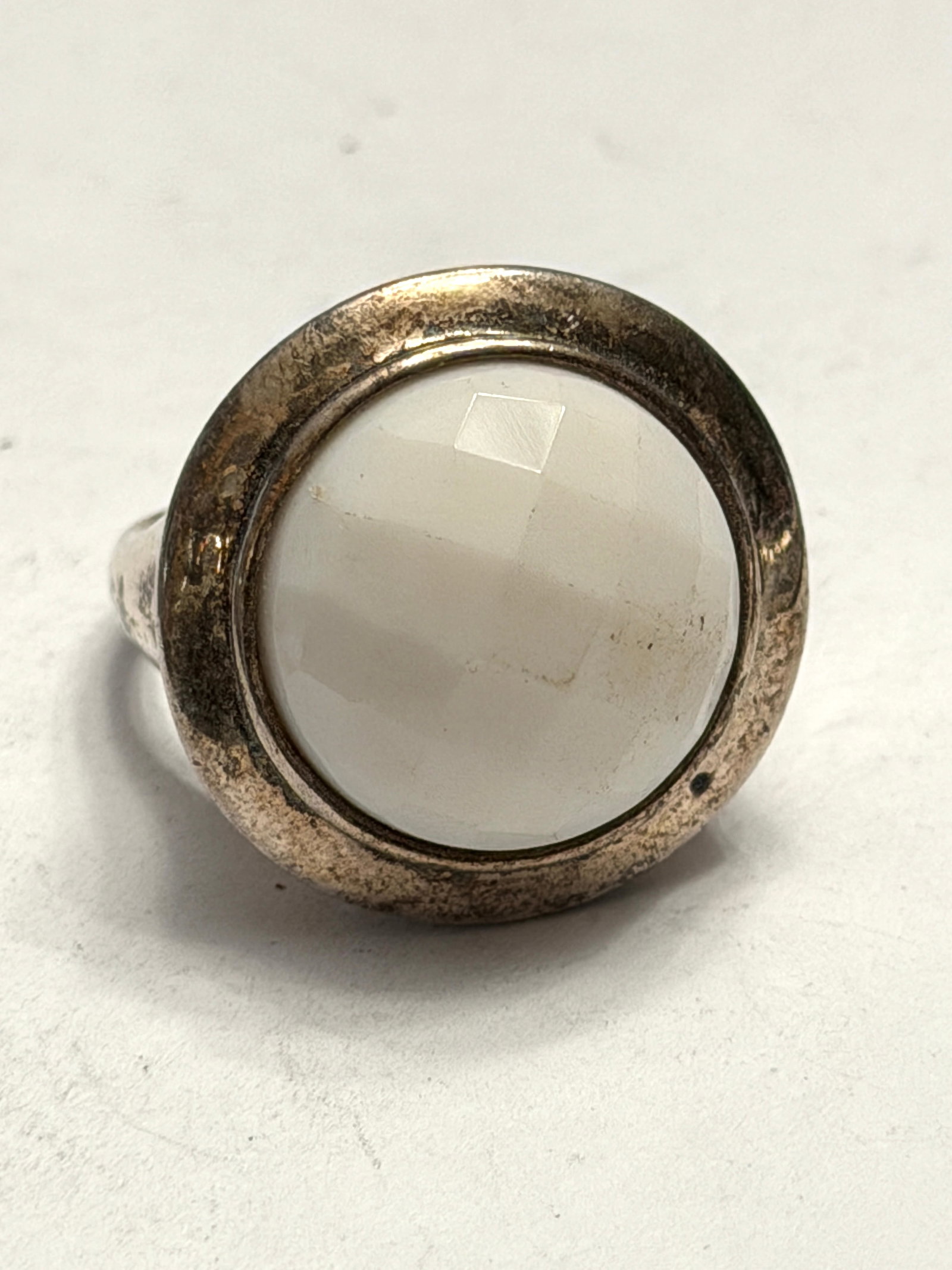 Vintage Sterling Silver White Faceted Cabochon Statement Ring Size 9: Bold vintage sterling silver statement ring featuring a large round white faceted cabochon stone in a smooth modern bezel setting. The milky white stone has a soft luminous appearance with subtle face