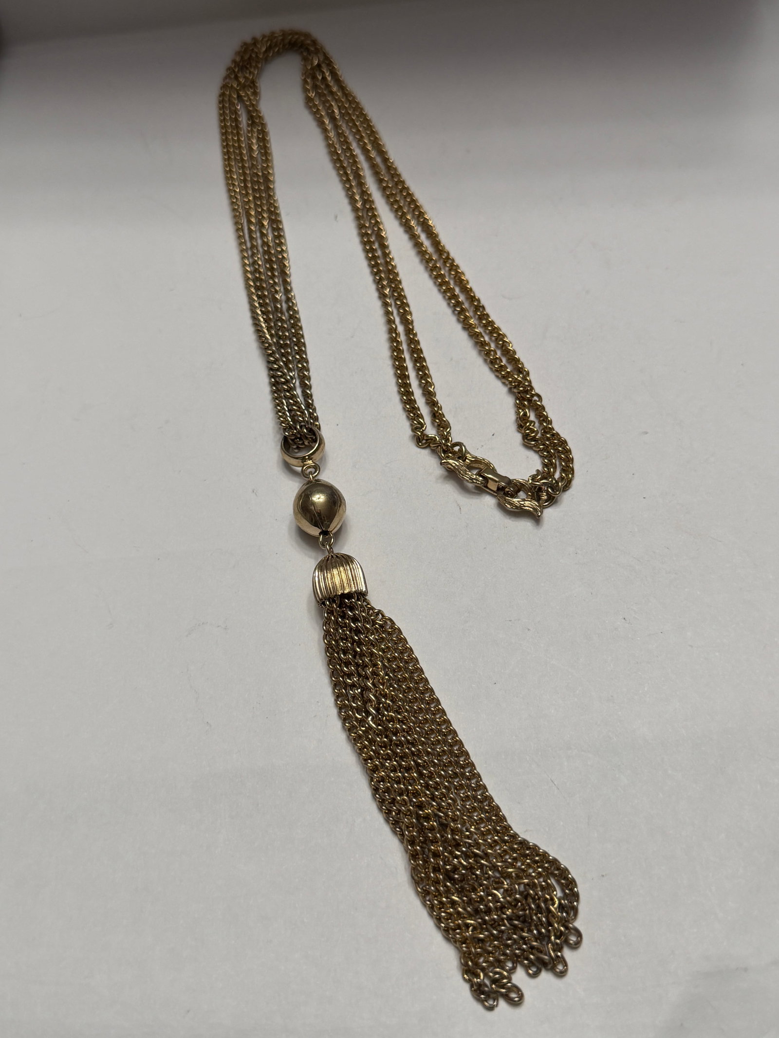 Lovely mixed lot of 8 vintage gold filled brooches and pins featuring elegant floral, Victorian: Elegant vintage gold tone tassel necklace featuring multiple chain strands with a dramatic fringe tassel drop pendant. The necklace has a layered chain design with decorative bead accents and an ornat