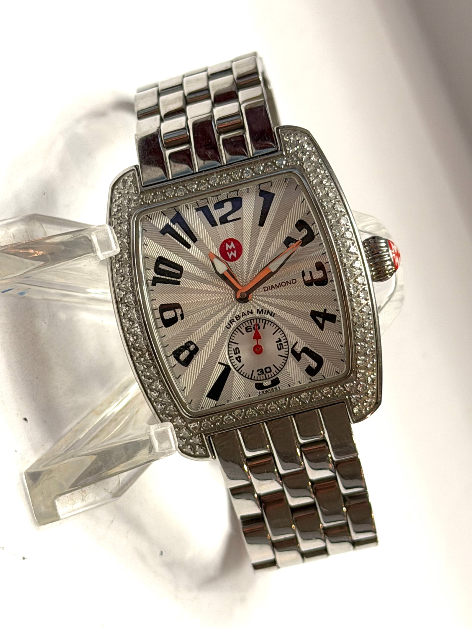 Michele Urban Mini Diamond Swiss Watch ? Stainless Steel with Diamond Bezel: Stylish and sophisticated Michele Urban Mini wristwatch featuring a polished stainless steel case and bracelet with a factory diamond-set bezel for an elegant luxury look. The silver textured guilloch