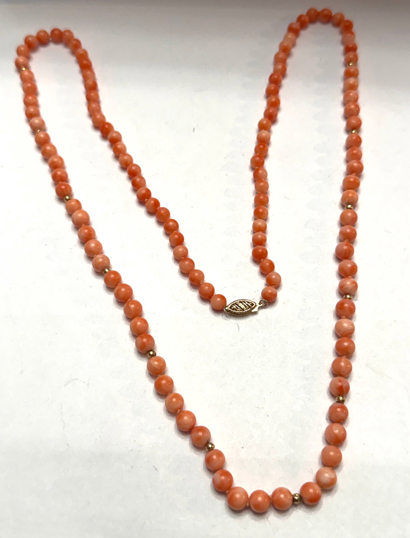 Vintage Pink Coral Bead Necklace 14K Gold Clasp Graduated Estate Jewelry 21.90 DWT: Beautiful vintage pink coral bead necklace featuring softly graduated round coral beads in warm salmon and blush pink tones accented with small gold spacer beads and finished with an elegant solid 14K
