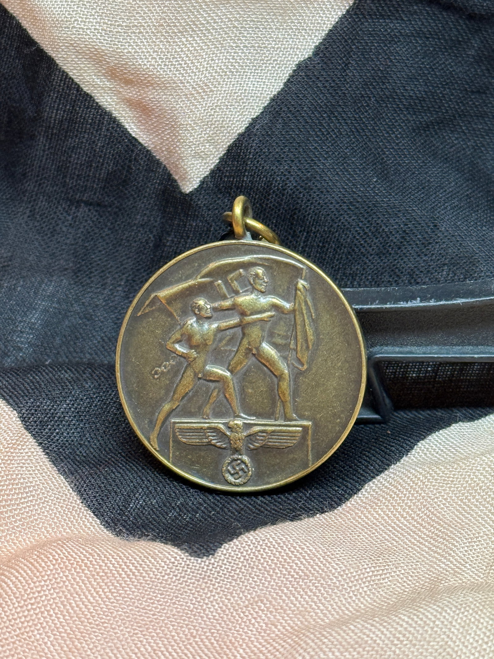WWII German Sudetenland Annexation Medal – 1 October 1938: This German medal commemorates the annexation of the Sudetenland into the Third Reich following the Munich Agreement of 1938. The obverse depicts two figures carrying a Nazi flag above a national eagl