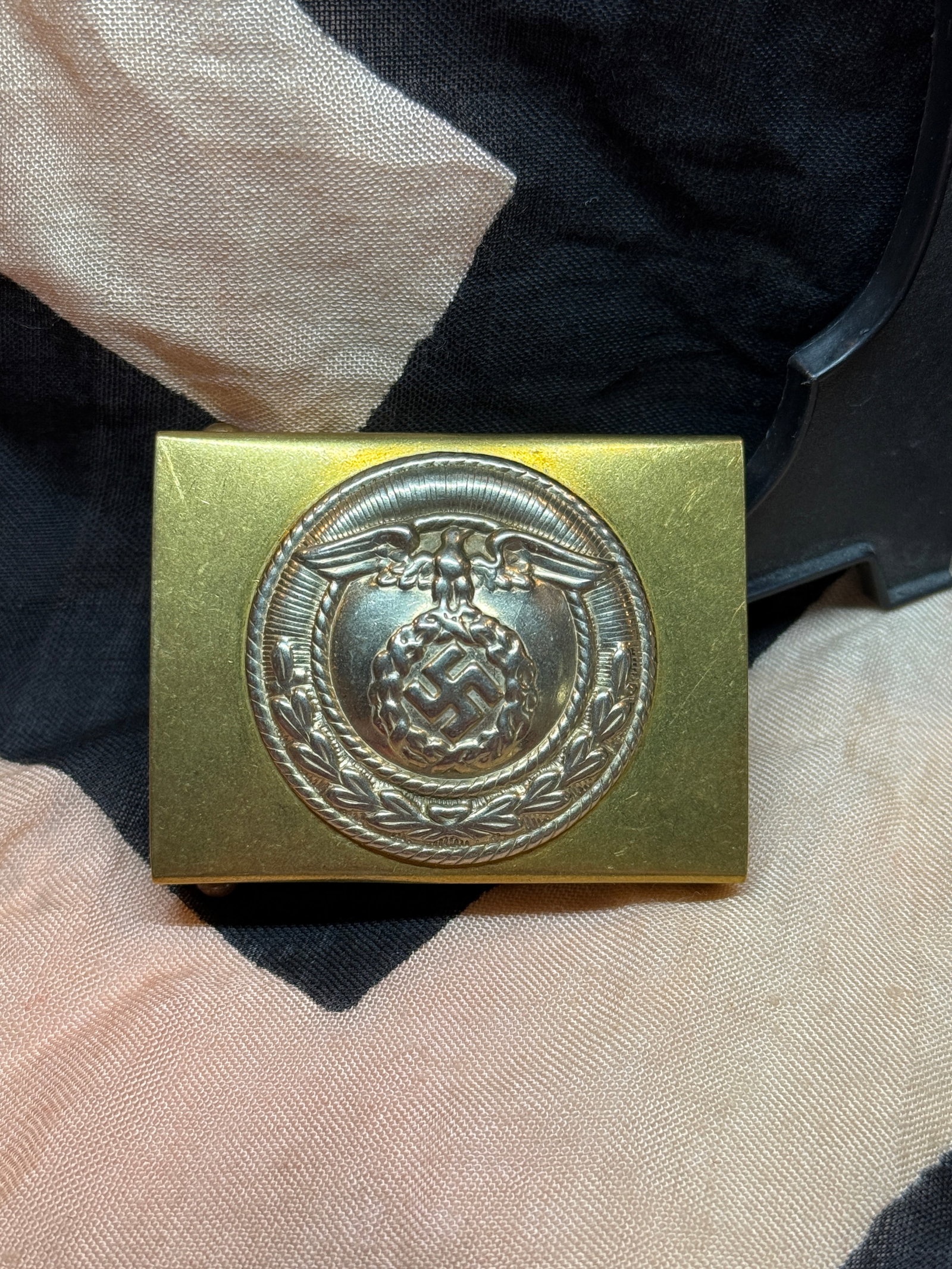 WWII German SA Sturmabteilung Belt Buckle Eagle Swastika Aluminum Brass Finish: WWII German SA (Sturmabteilung) belt buckle featuring the Third Reich national eagle above a wreathed swastika. Constructed in the classic rectangular SA pattern with a brass-toned body and silver-col