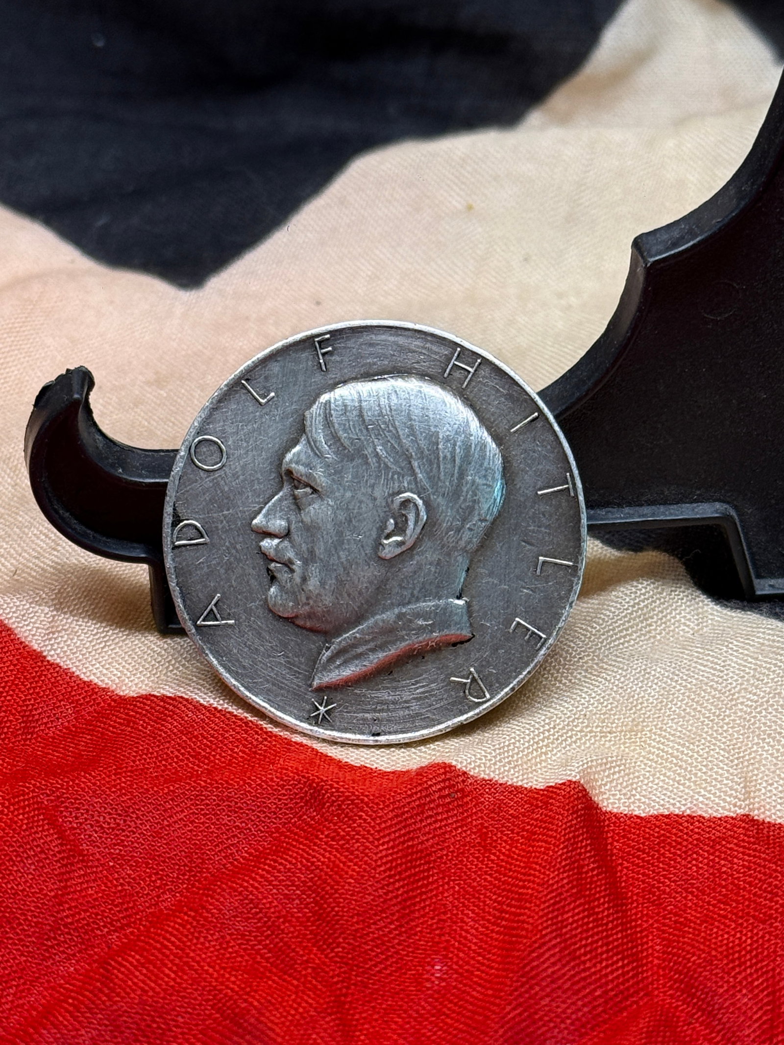WWII German Adolf Hitler Patriotic Commemorative Medallion: This circular German medallion features a left-facing profile portrait of Adolf Hitler surrounded by the inscription “ADOLF HITLER.” The reverse bears the German nationalist slogan “DU BIST 