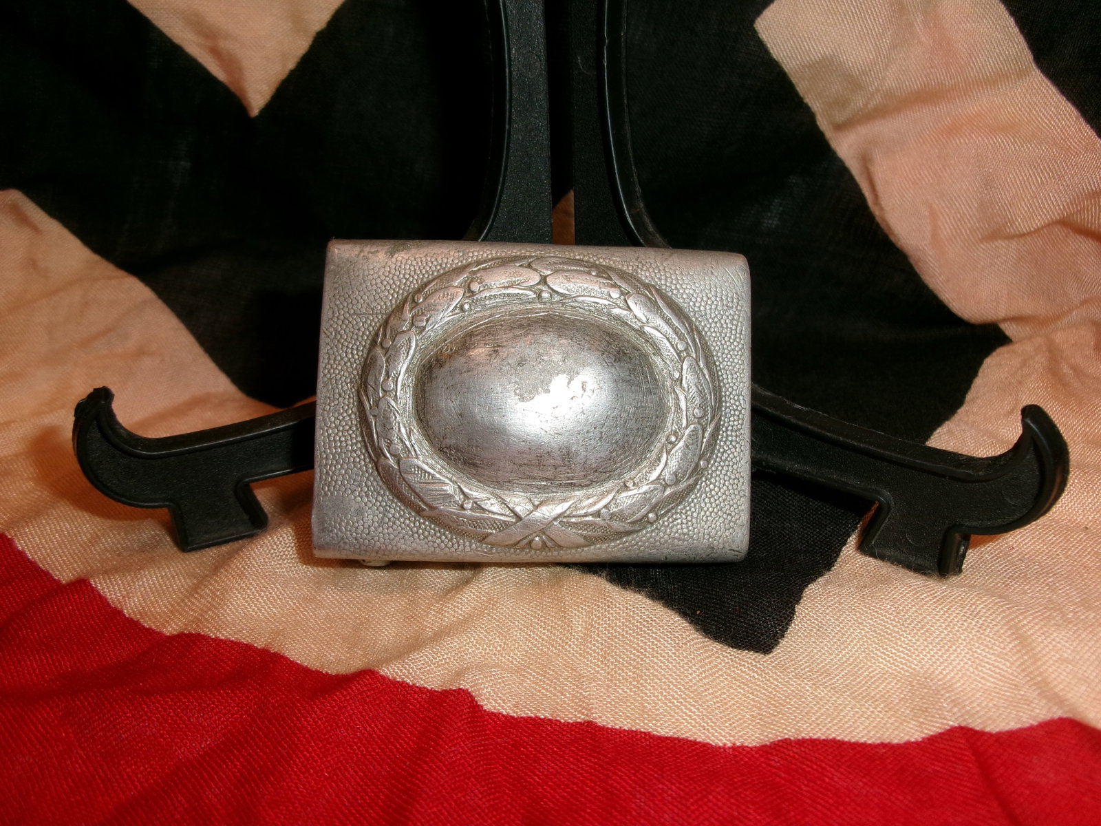 WWII German Luftwaffe Aluminum Belt Buckle: This aluminum belt buckle is a standard enlisted-pattern buckle used by the German Luftwaffe (Air Force) during WWII. The front features the characteristic Luftwaffe-style wreath surrounding a smooth 